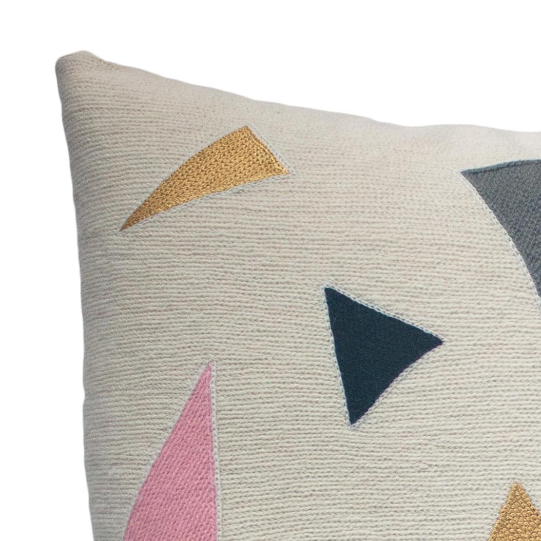 This geometric throw pillow has been ethically hand embroidered by artisans in Kashmir, India, using a traditional embroidery technique which is native to this region.

The purchase of this handcrafted pillow helps to support the artisans and