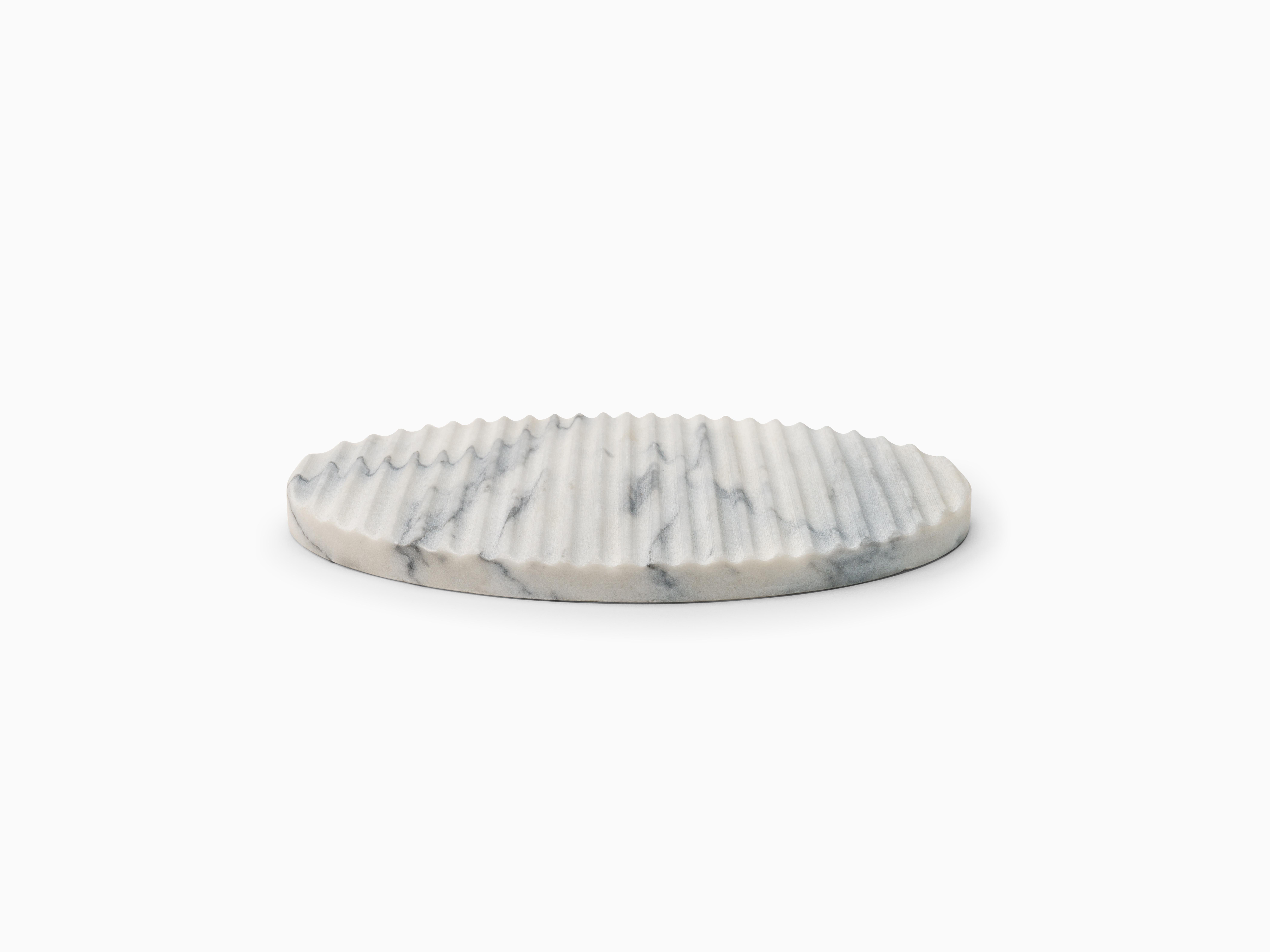Manuel Aires Mateus creates four elegant stone platters inspired by a simple, circular shape, with beautiful Estremoz marble stone grooved in a classic pattern. Its unique look is achieved by placing vertical grooves carved in its pristine surface,