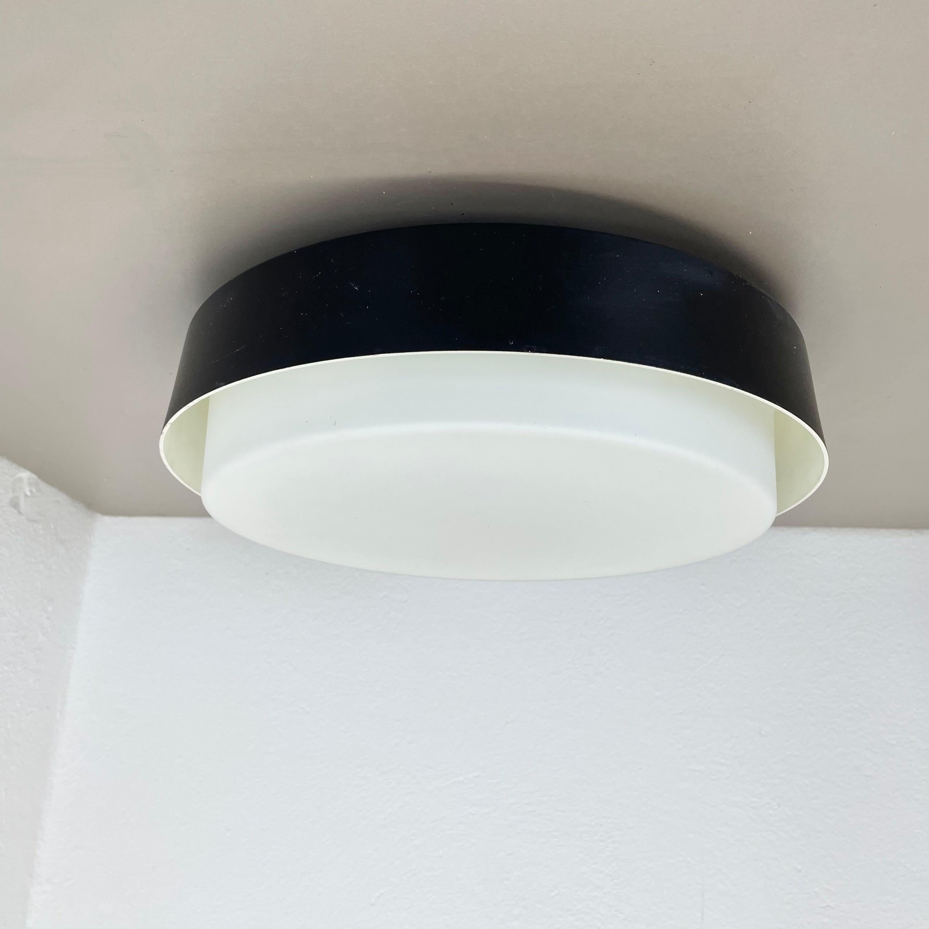 Article:

wall light, ceiling light


Producer:

Bega Lights, Germany



Origin:

Germany



Age:

1980s



Original 1980s modernist German wall Light made of high quality satin glass with a a brutalist black metal wall fixation element . This super