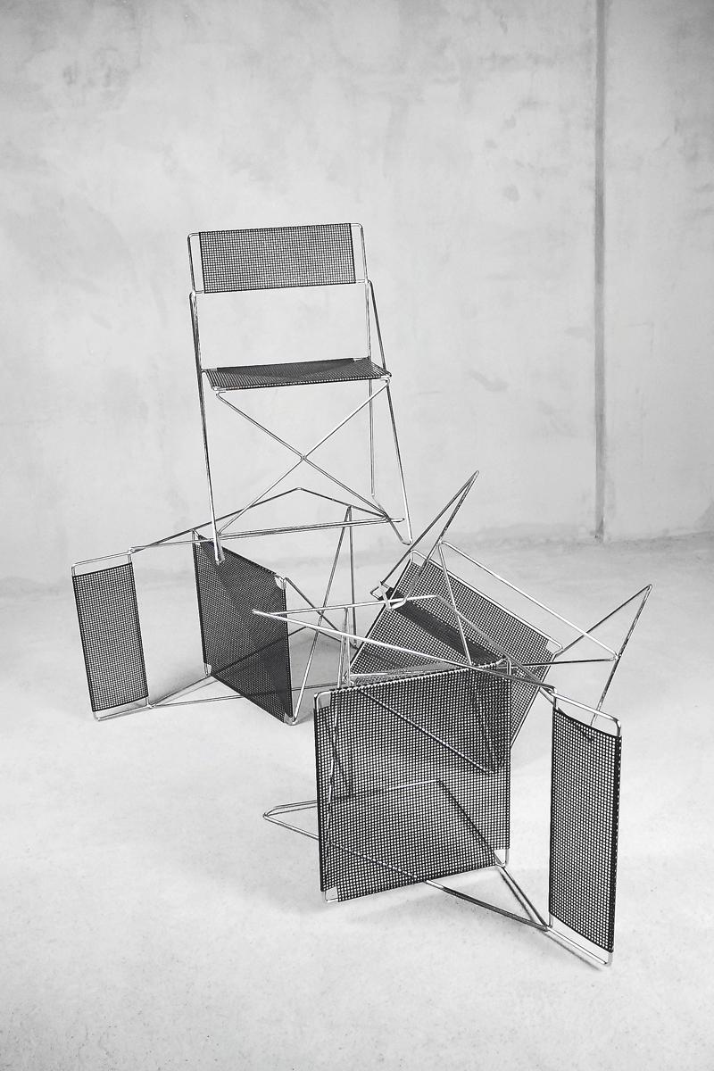 This rare set of four stacking X-Line chairs was designed in 1977 by Niels Jørgen Haugesen and produced by Hybodan A/S in Denmark. They are made of chrome-plated steel rods and a black enamelled perforated steel back and seat. This model can be use