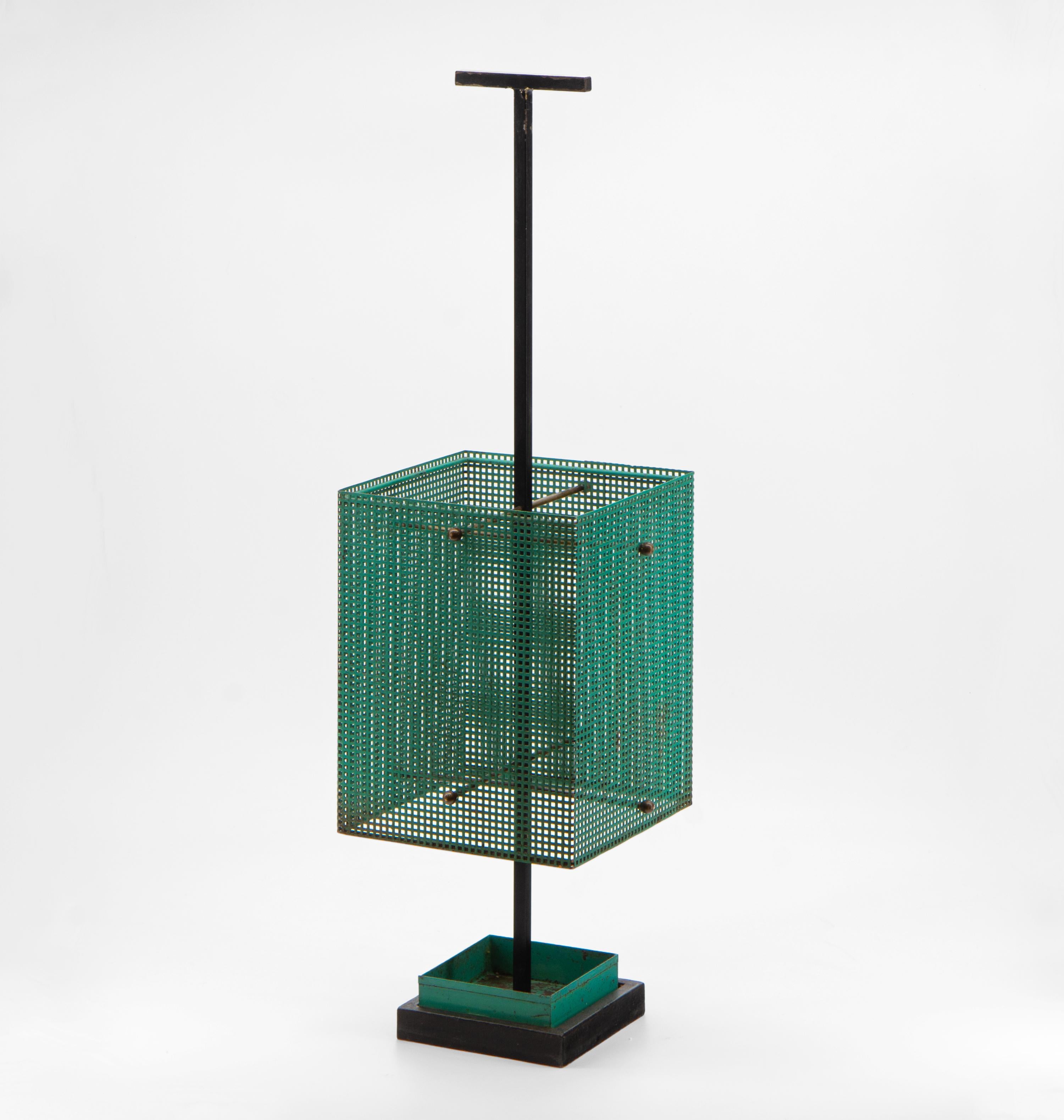 A sleek, minimalist mid-century Brutalist perforated metal umbrella stand. European - Circa 1950.

Free UK delivery.

The stand has the original green finish to the perforated metal. The drip tray is inset with a central T shape handle and brass