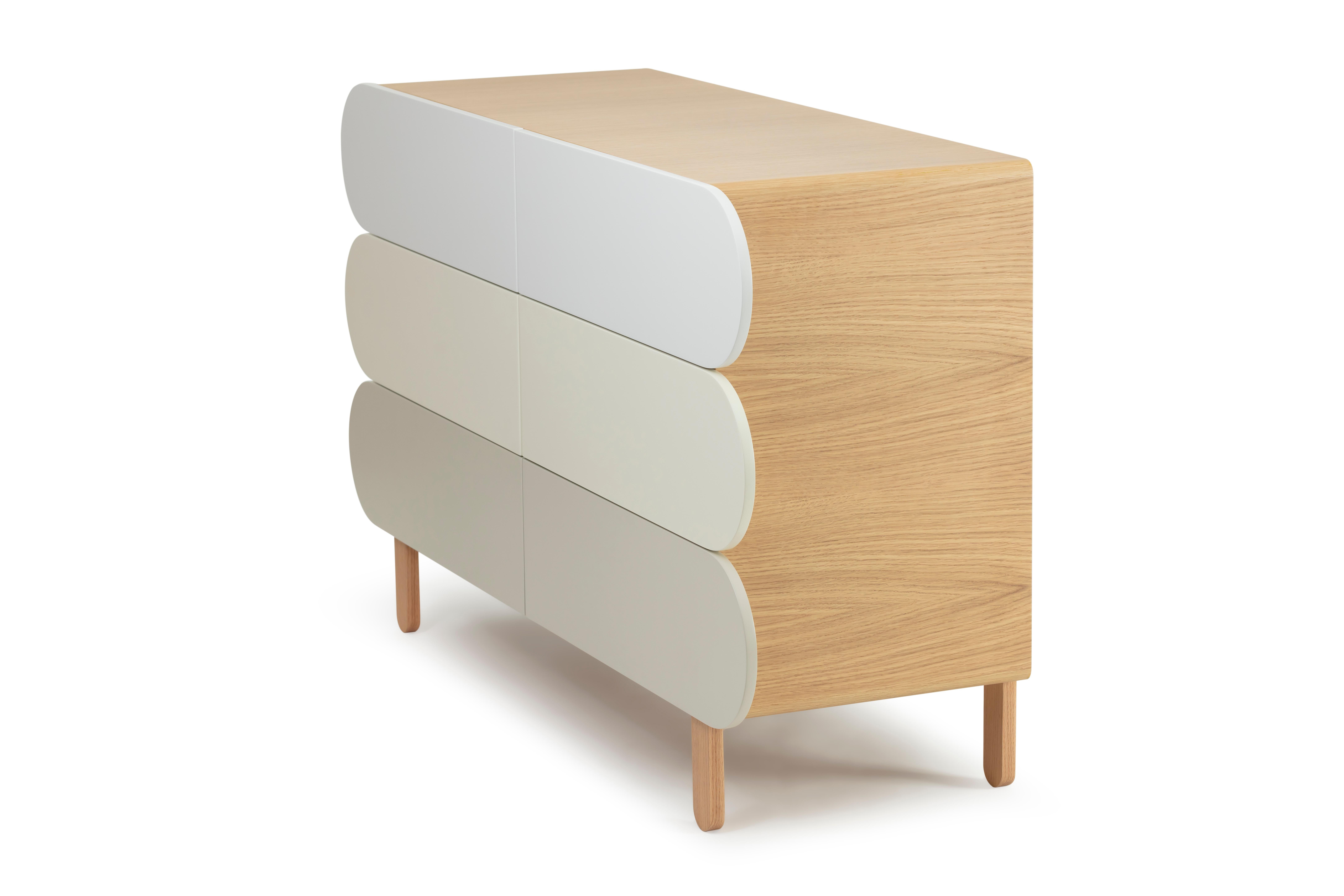 Crafted in wood veneer and a colorful facade, this modern dresser showcases an organic yet stylish silhouette flaunting straight clean lines. Six drawers open to reveal generous storage space to stow your everyday essentials in a covert fashion.