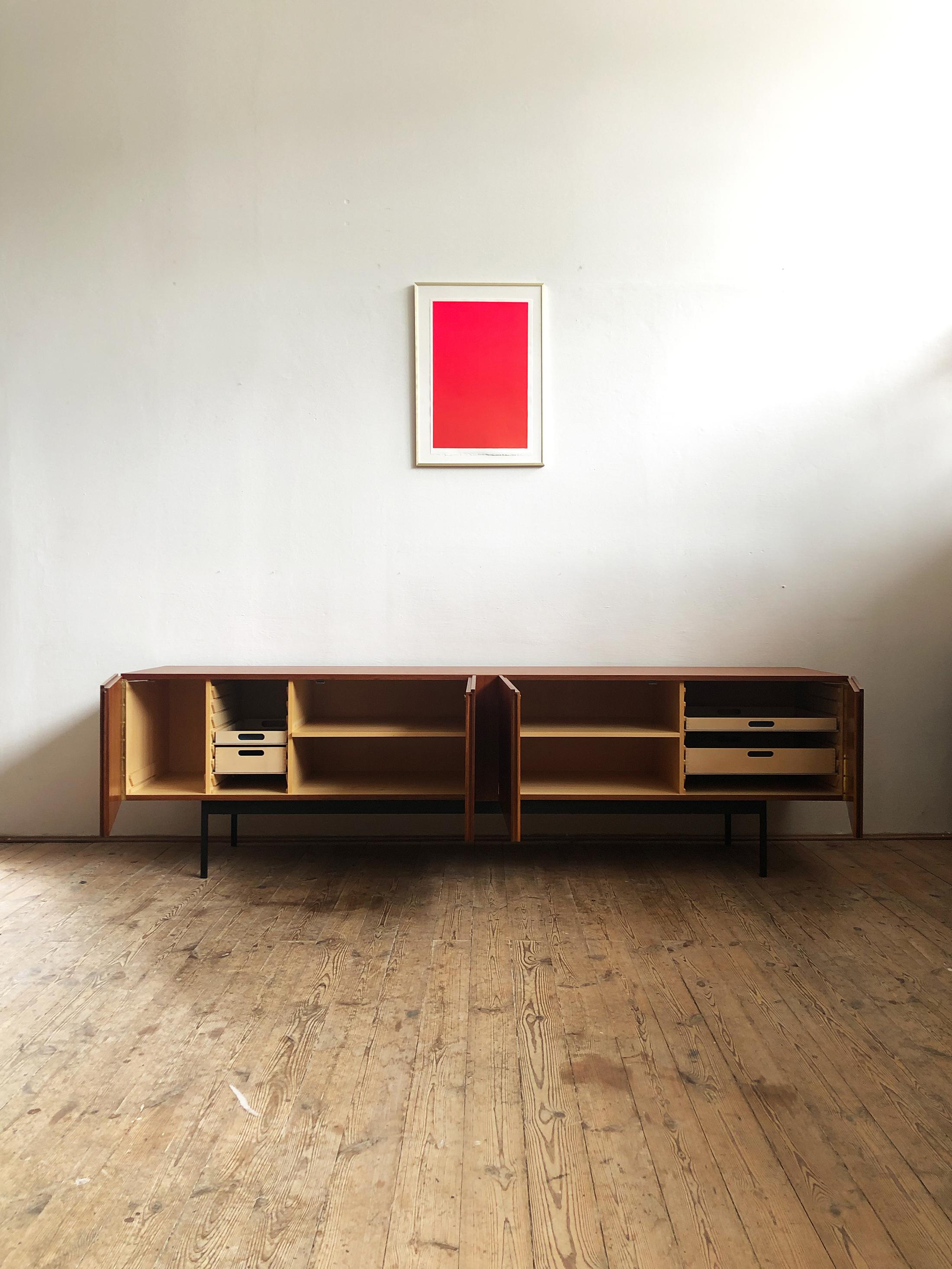 Minimalist Mid Century Teak Sideboard, B40 by Dieter Waeckerlin for Behr

Rare Dieter Waeckerlin model B40 sideboard for Behr, Germany, 1950s.
Made of teak veneer with nice grain and a black steel metal base. 
The inside is made of beech.