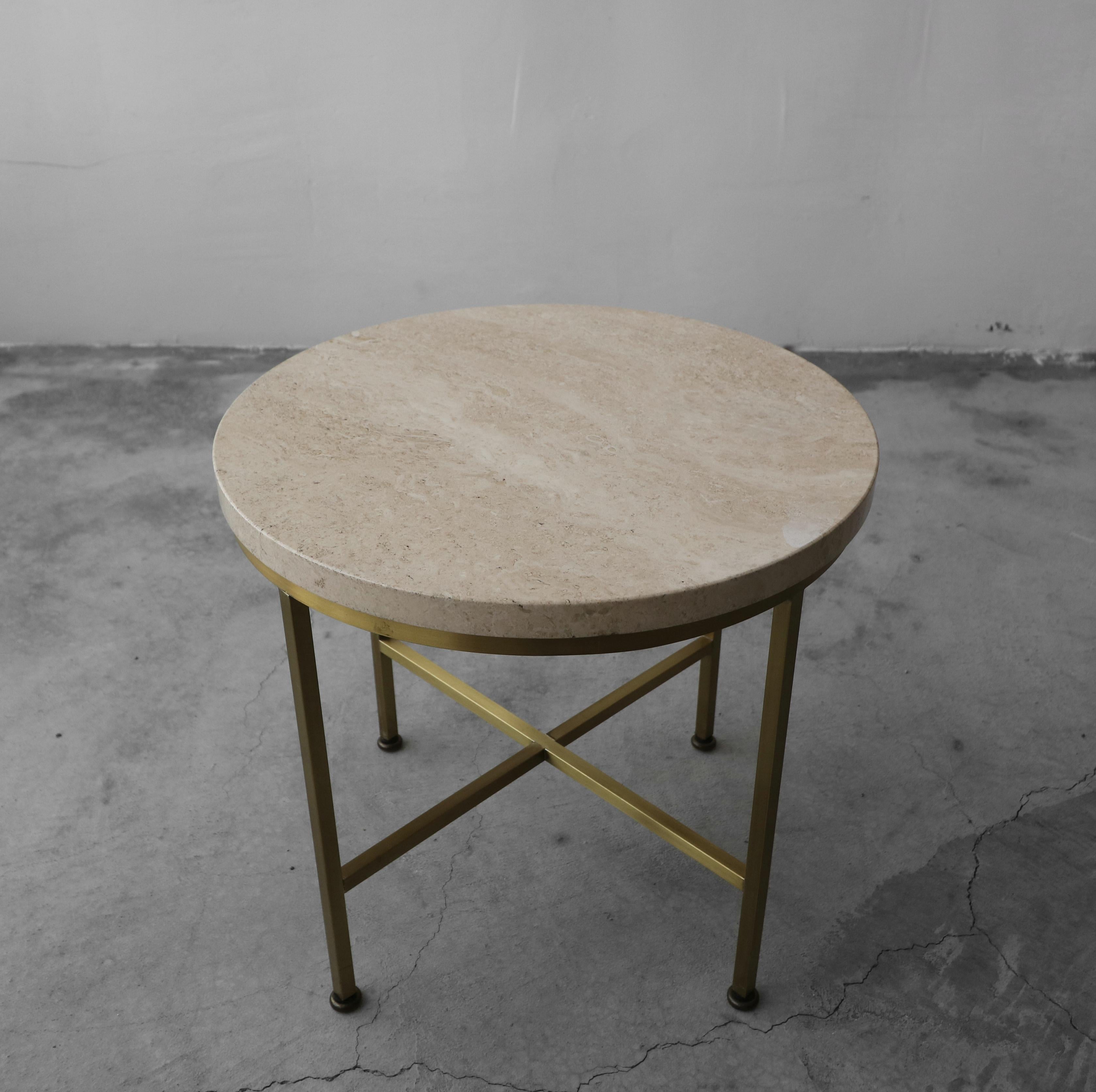 Beautiful side table by Paul McCobb. Simple but never understated. Round Italian Travertine slab combined with the Classic brass McCobb base.

Table is in pristine original condition.