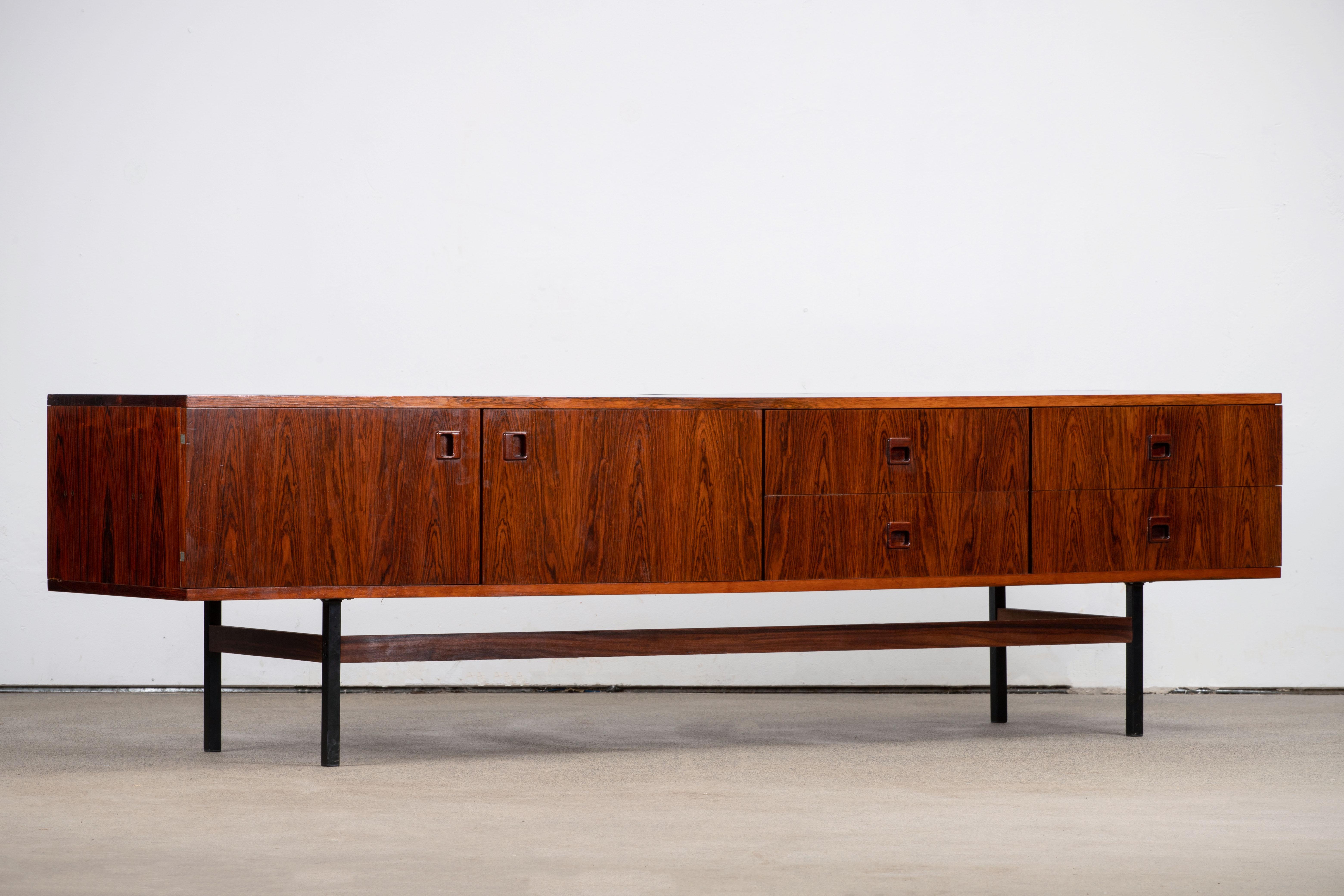 Mid-century Cocobolo sideboard from the 1960s. It is a shining example of the form and function synonymous with furniture of this era. Well-built, great design and lightness. Three drawers storage space. The minimal design and the warm tone combined