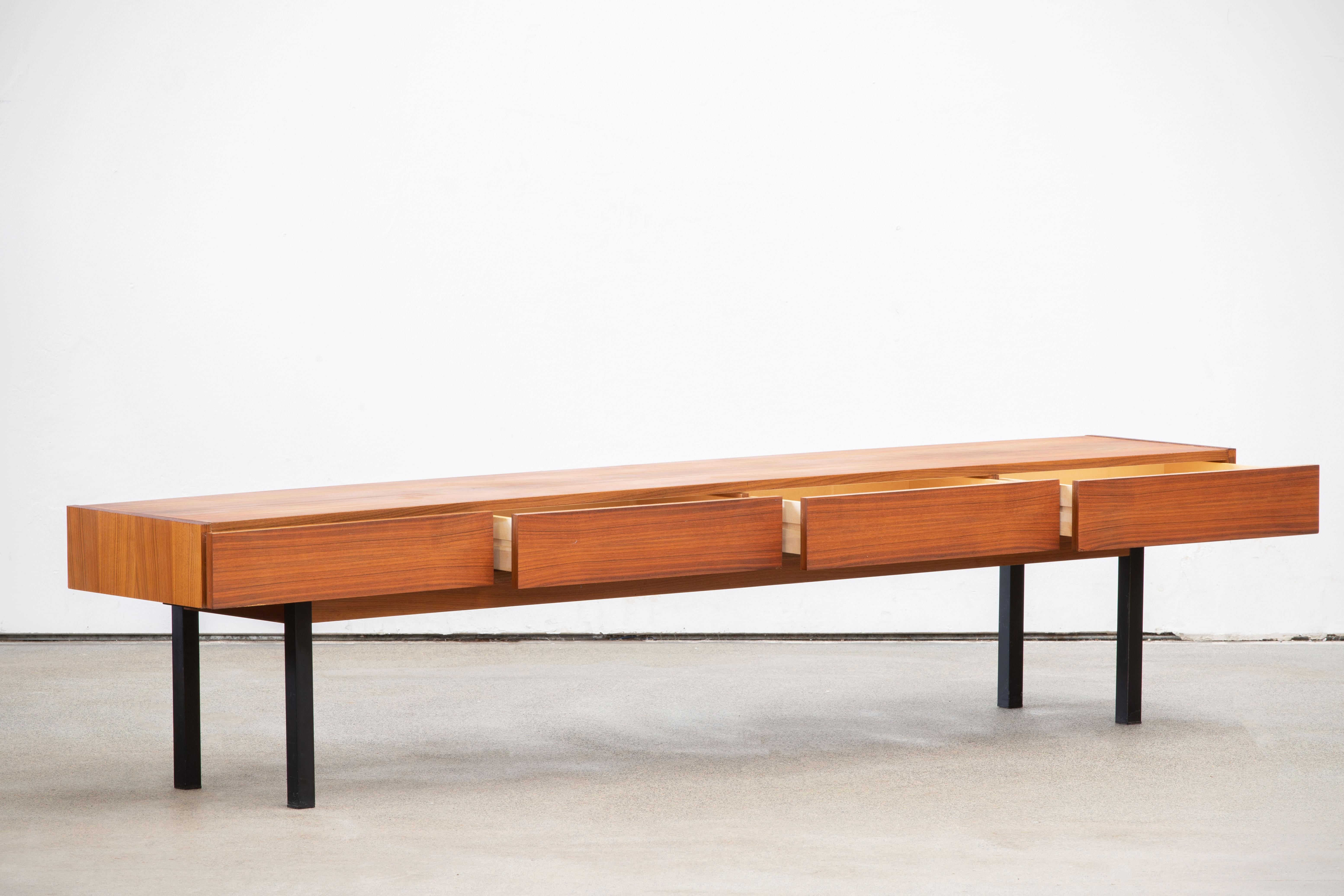 Midcentury teak sideboard from the 1960s. It is a shining example of the form and function synonymous with furniture of this era. Well-built, great design and lightness. Three drawers storage space. The minimal design and the warm tone combined with