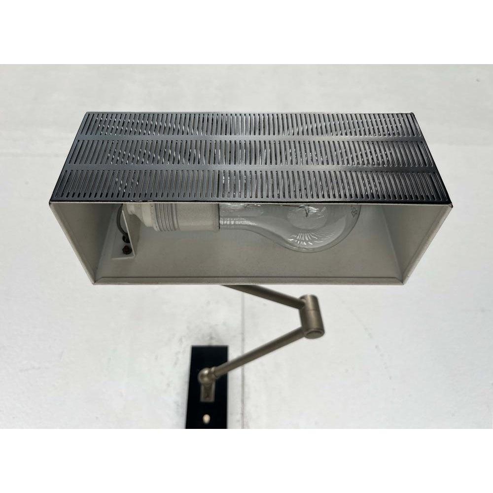 Mid century wall lamp from the german manufacturer bur leuchten.
cubic shapes permeate this design, from the shade to the wall panel. The most striking detail of these bur designs is the fine perforation of the umbrellas. A rectangular elongated