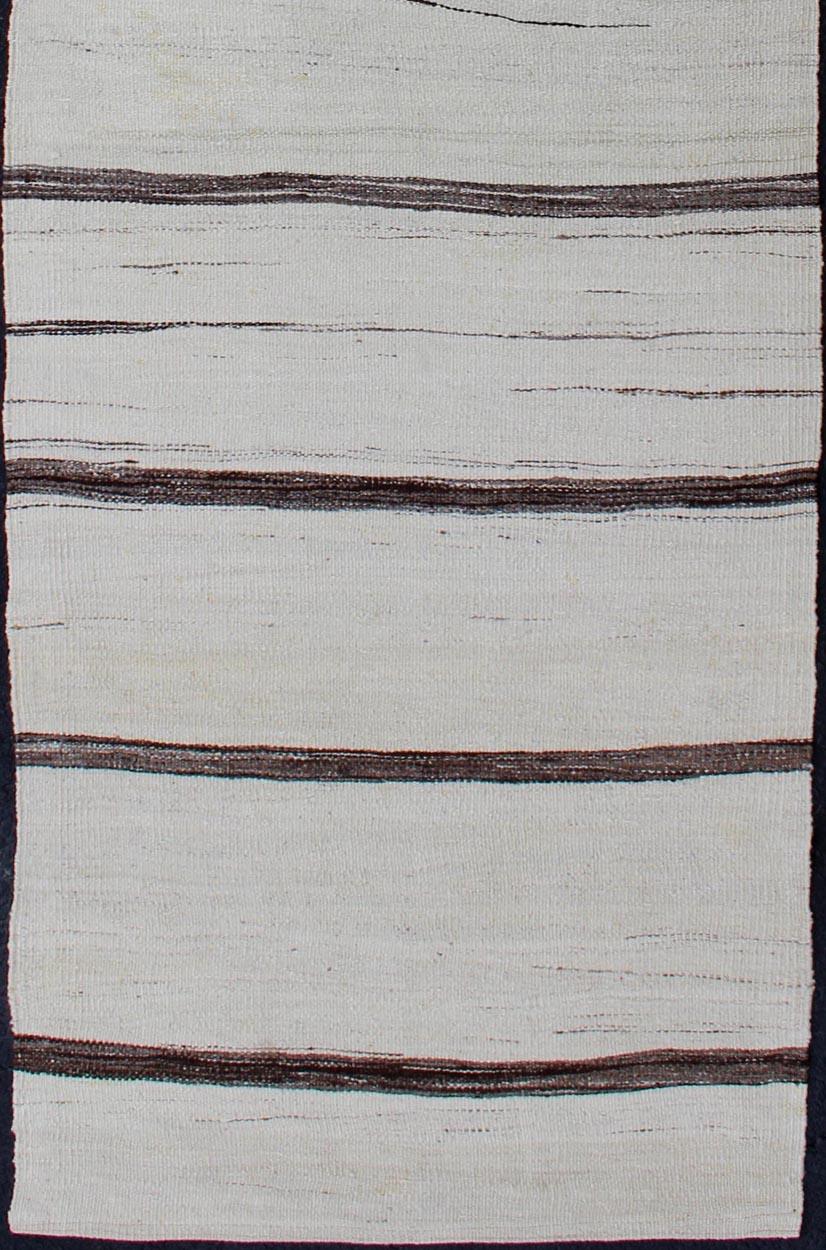 Minimalist Modern Design Flat-Weave Kilim with Stripes of Brown on Ivory Ground. Keivan Woven Arts /  rug EN-165991, country of origin / type: Turkey / Kilim, circa 1950
Measures: 2'7 x 8'6.
This modern-design vintage runner from Turkey features a