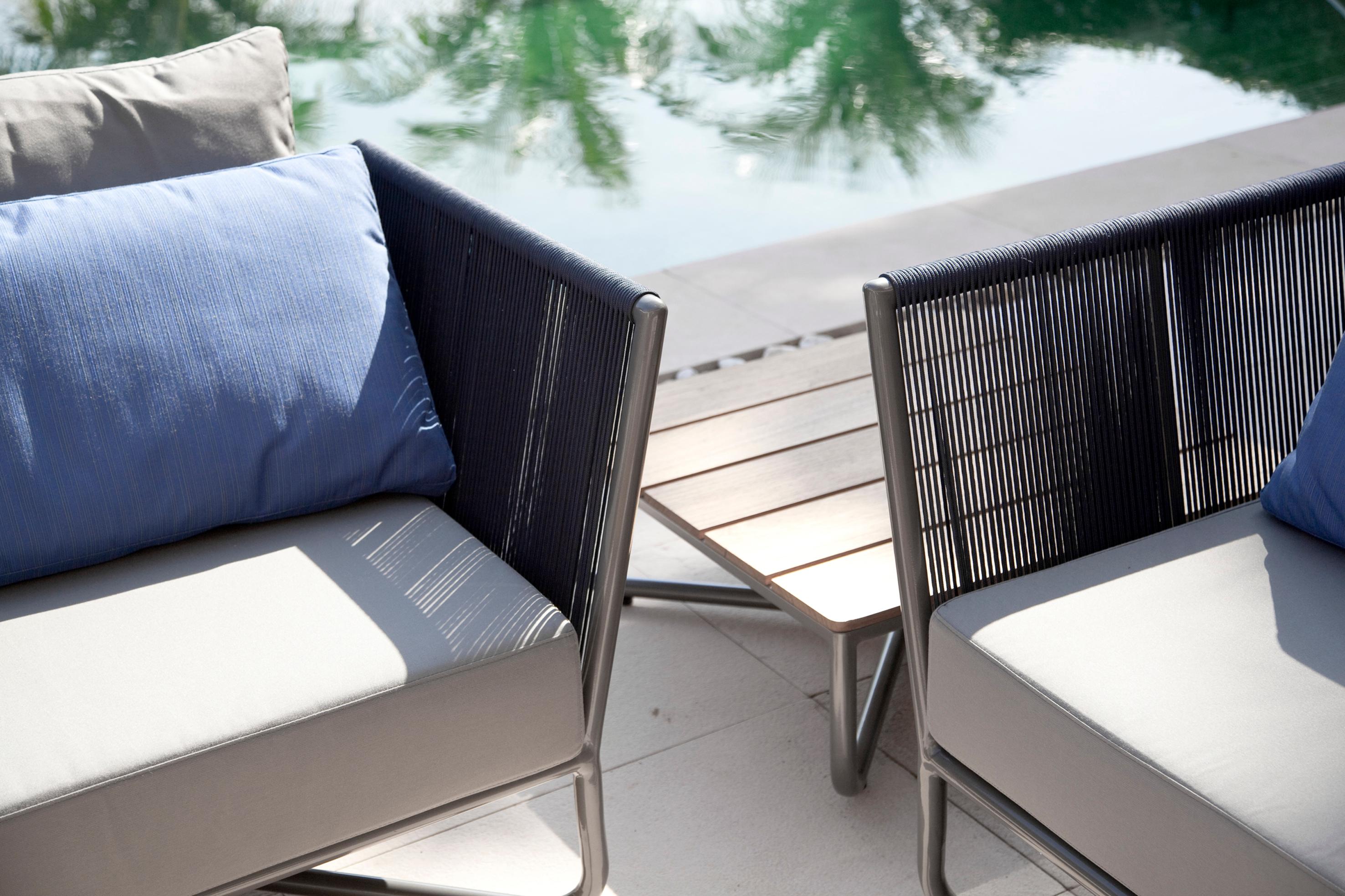 Dieser Sessel oder Lounge-Sessel für den Außenbereich ist Teil der Flap 2.0 Outdoor-Kollektion, deren Design auf den Klappen von Flugzeugen basiert. Dieses Element lässt sich an der Krümmung der Arme und der Geometrie der Metallstruktur erkennen.