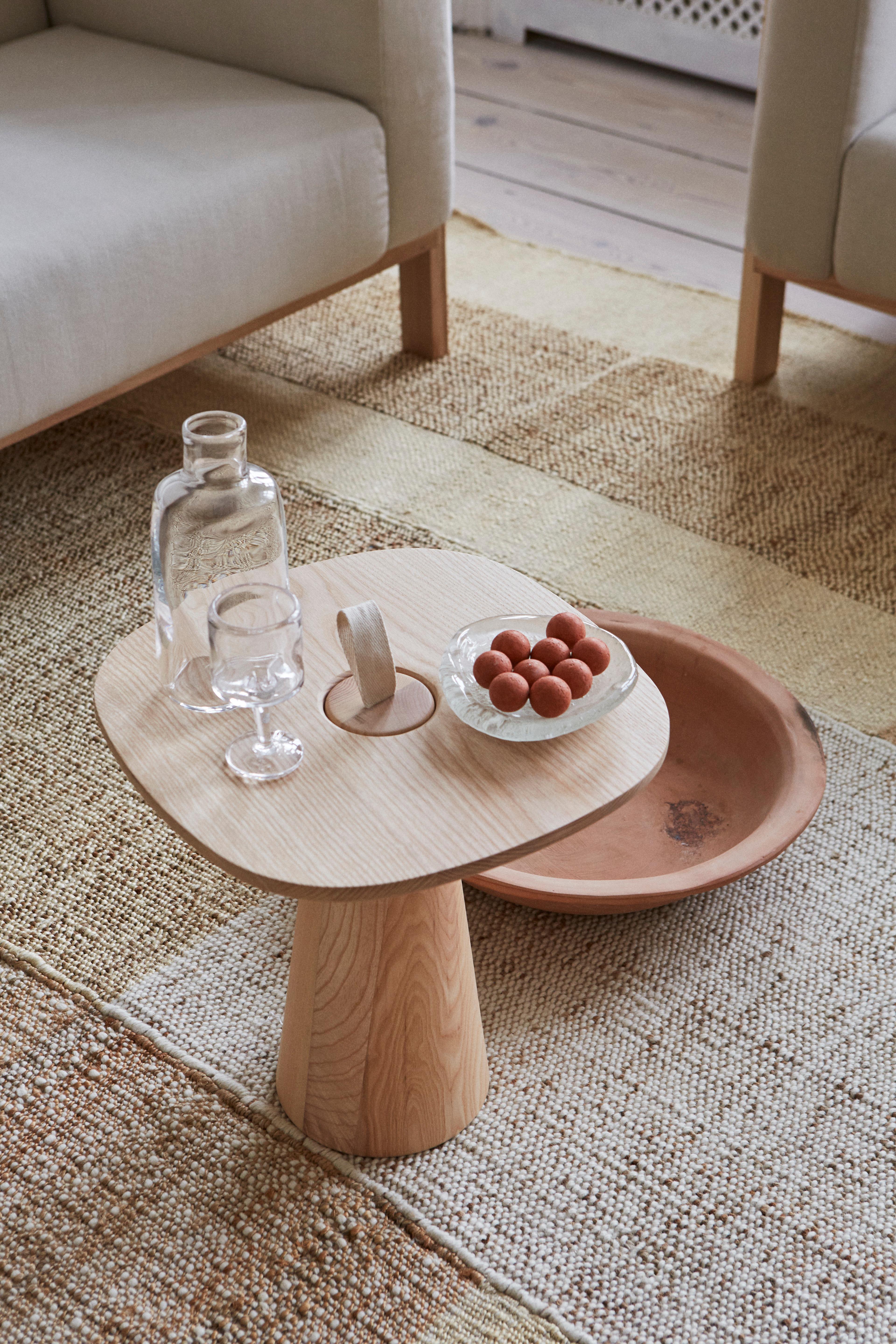 Der minimalistische MIGO-Tisch besteht aus zwei Teilen: einer Tischplatte und einem konisch geformten Sockel, dessen Oberseite mit einem Gurt zum Anheben endet.

Die weiche und freundliche Form der Platte macht den Tisch für verschiedene