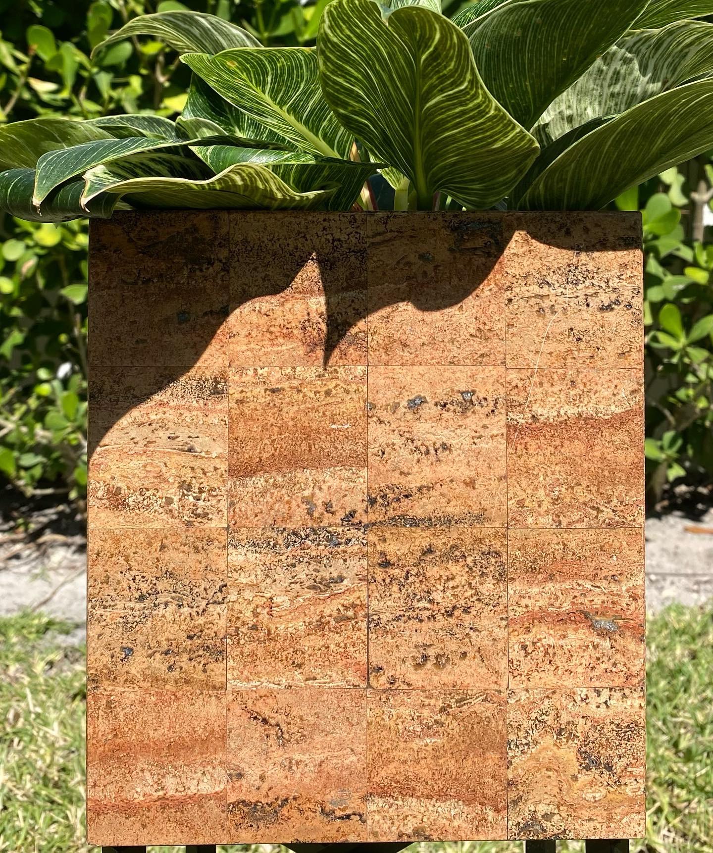 Uncommon red travertine geometrically tessellated cube form planter. Substantially weighted stone piece with great presence, color and texture. 

We love a clean line and a planter in a geometric form, softened by foliage is the perfect combination