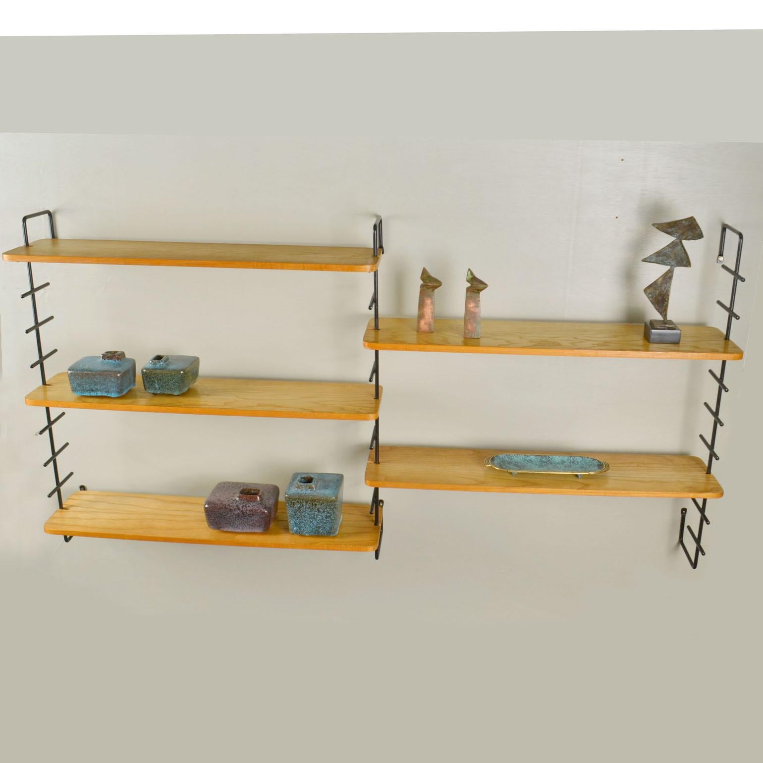 Minimalist modular wall mounted shelving unit with three metal uprights and five oak veneered shelves, Swiss 1960's.
Each shelf measures 75-20 cm