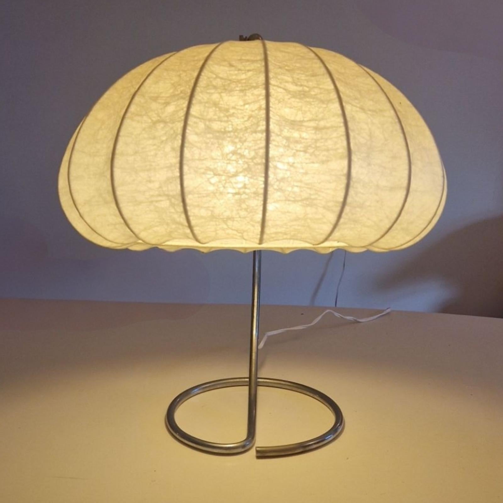 Modernist desk or table lamp. The base is made from a single piece of nickel plated tube. The socket is adjustable in angle and rotatable.
Fitted with a cocoon shade in the style of Achilles Castiglioni
The shade is not original to the base but