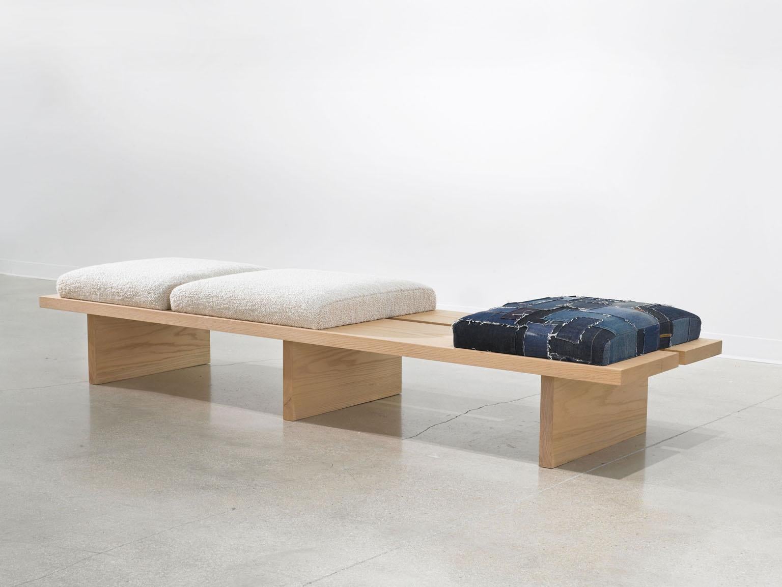 The 'Heroes Bench' was inspired by the clean solid oak planks and designed to emphasize the beauty and simplicity of the materials nature. The adjustable seat cushions are upholstered in Natural Bouclé made by David S Gibson custom weavers and a