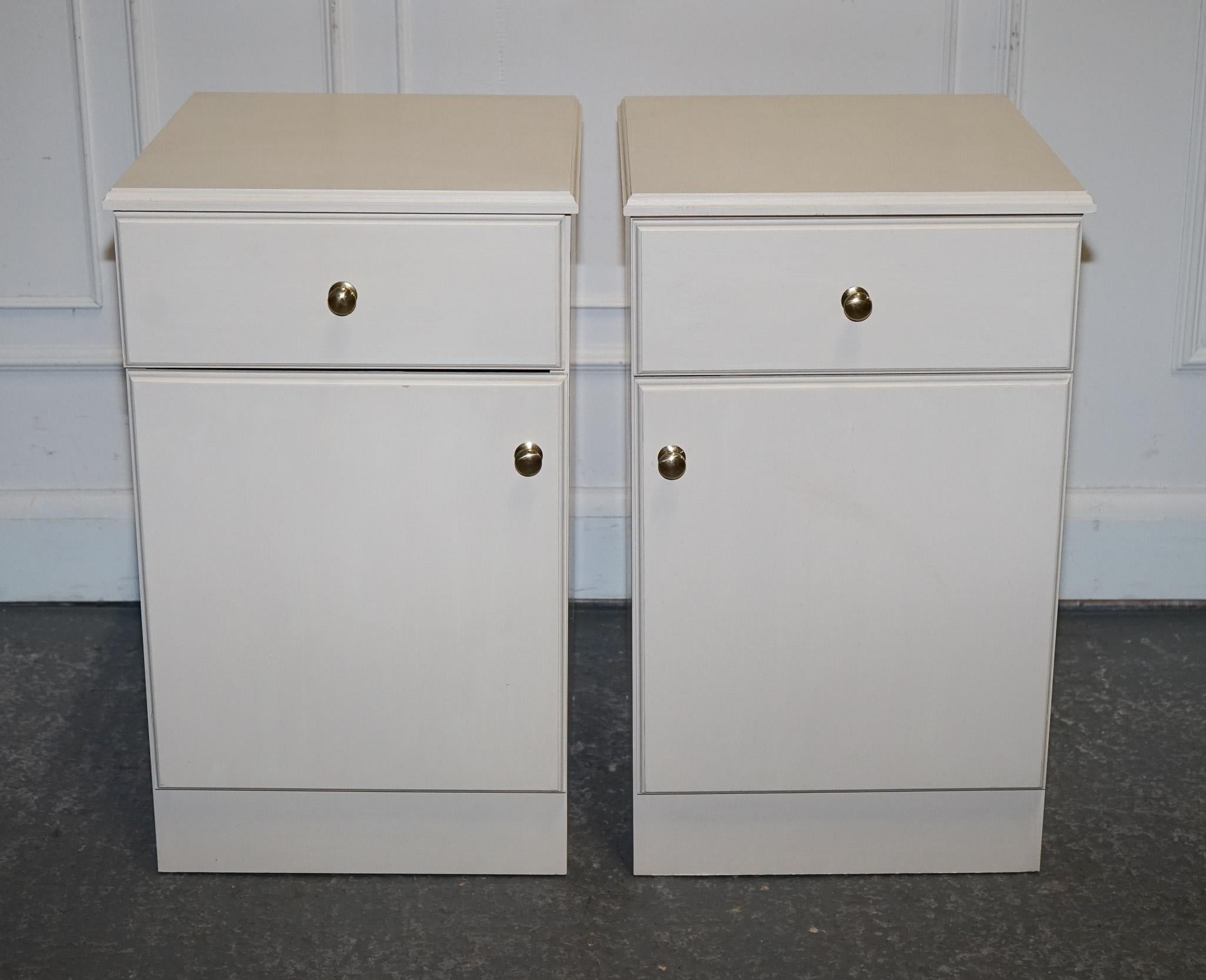 
Antiques of London



This pair of white bedside cabinets blends sleek design with practical storage — ideal for modern or transitional interiors. Each unit includes a smooth-gliding drawer and a lower cupboard with a brass knob, offering both