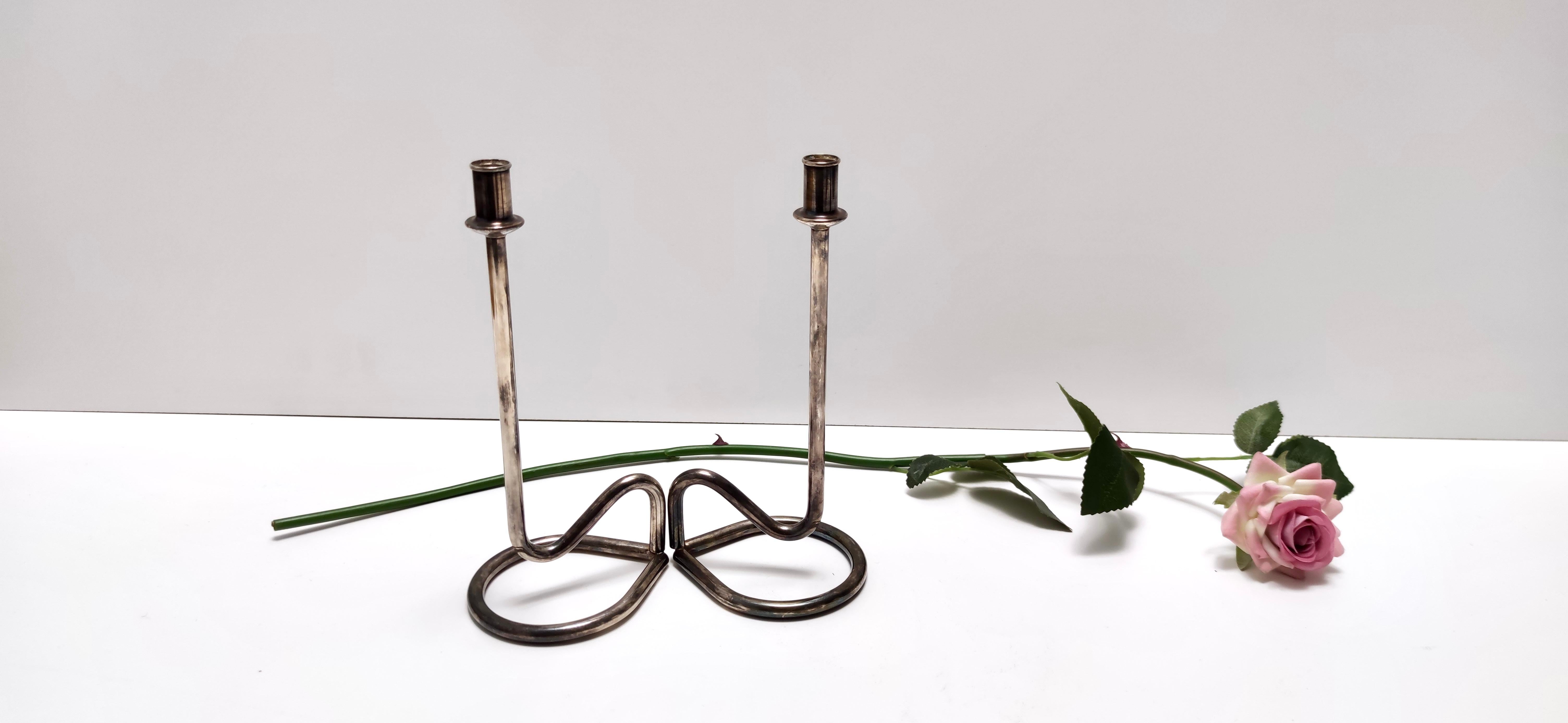 Made in Italy, 1990s. 
They are made in silver plated metal. 
These candleholder are vintage, therefore they might show slight traces of use, but they can be considered as in very good original condition and ready to become a piece in a home. 
On