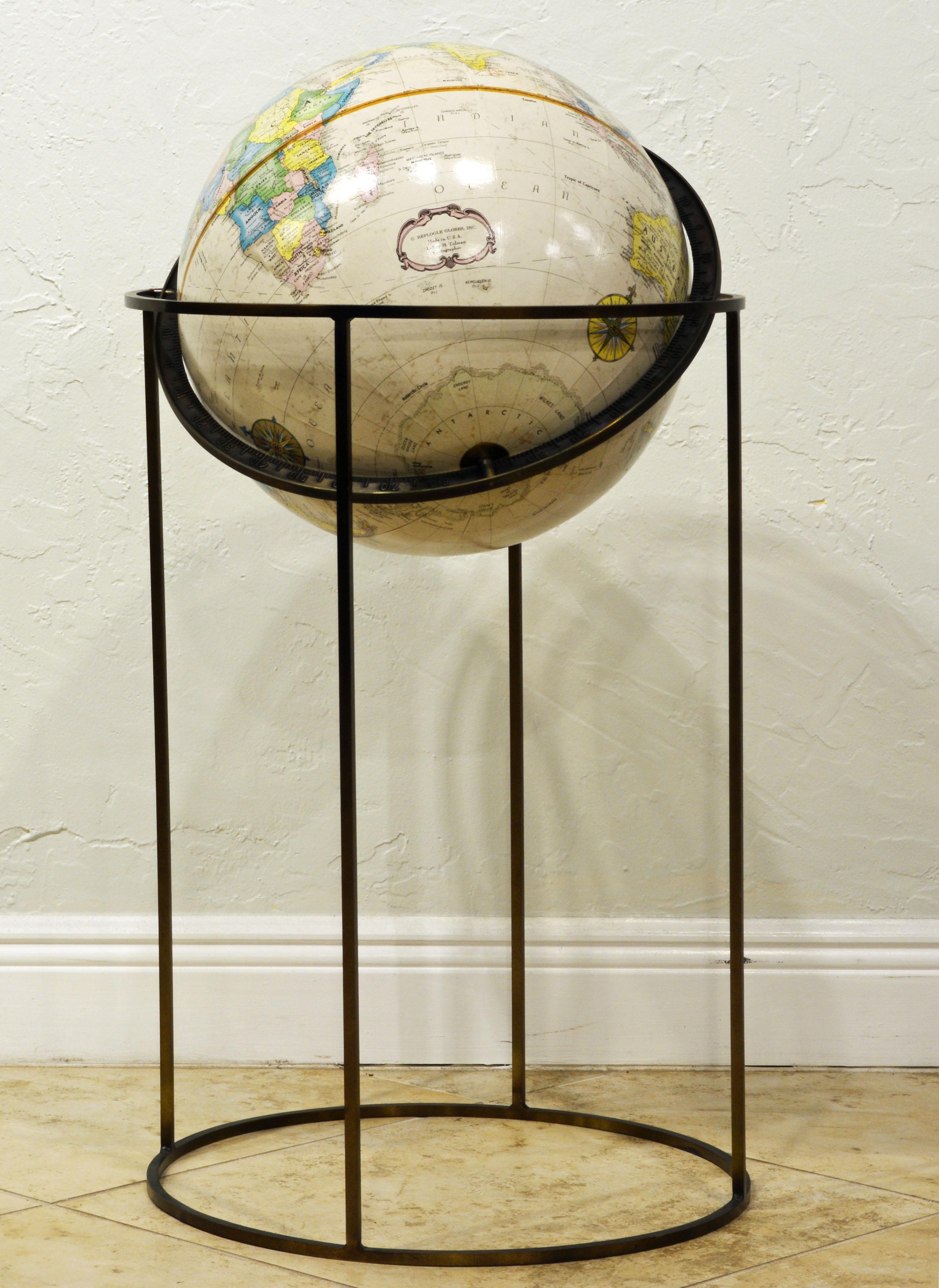 Elegant and Minimalist in design this vintage globe which is attributed to Paul McCobb is a statement of modernism. The globe itself is 16 inches. The Stand is made of solid brass which over time has attained an attractive patina.