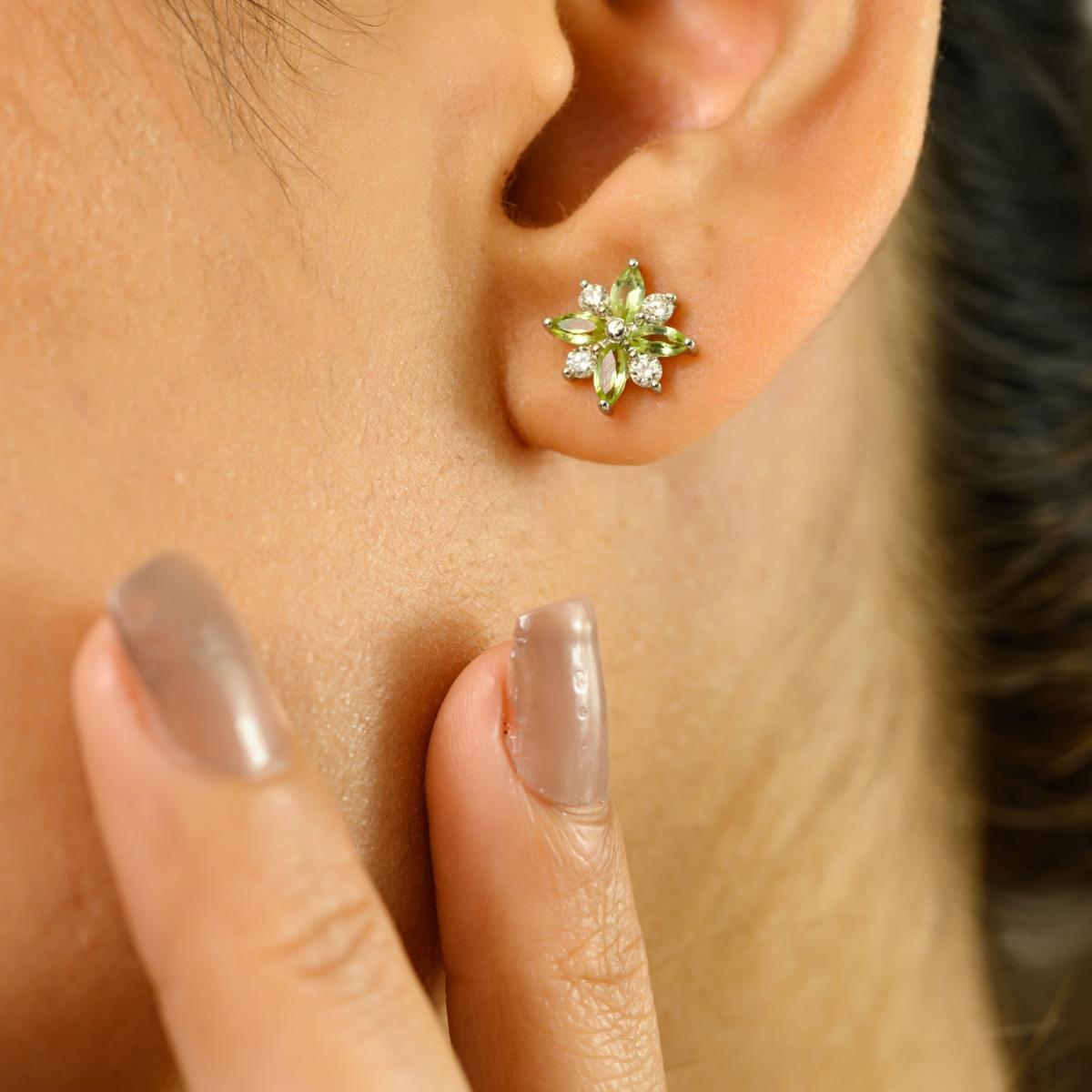 Questi orecchini di ispirazione floreale, che emanano charme ed eleganza, sono realizzati in luminoso oro bianco 14 carati. Ogni orecchino presenta una delicata composizione di pietre verdi con taglio a marquise per un totale di 0,75 carati,