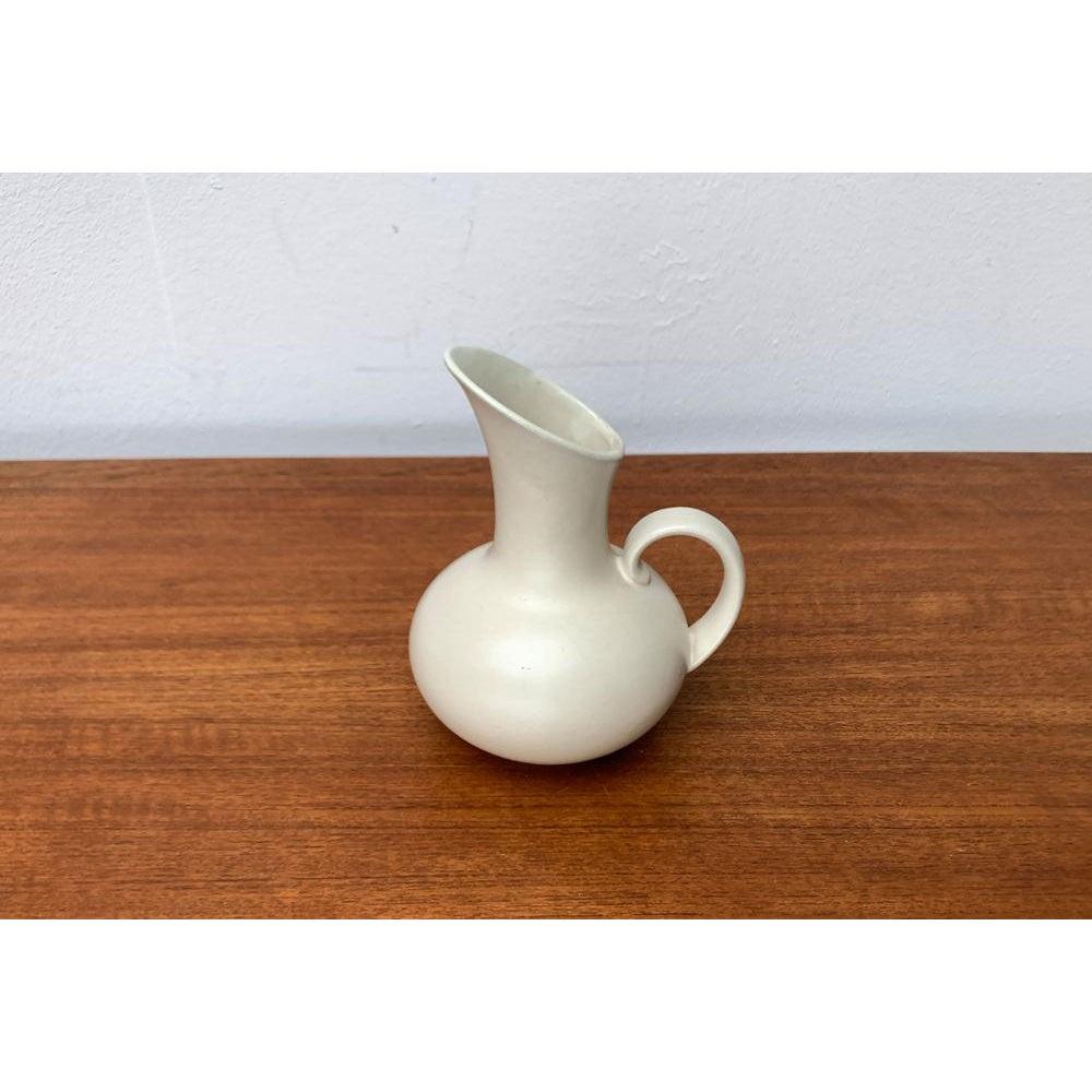 Minimalist Pottery Carafe Vase from Steuler, West Germany, 1960s, in Very Good conditions. Designed 1960 to 1969 This piece has an attribution mark.

Additional information:
Materials: Ceramic
Color: Ivory
Styles: Mid-Century Modern
Country of