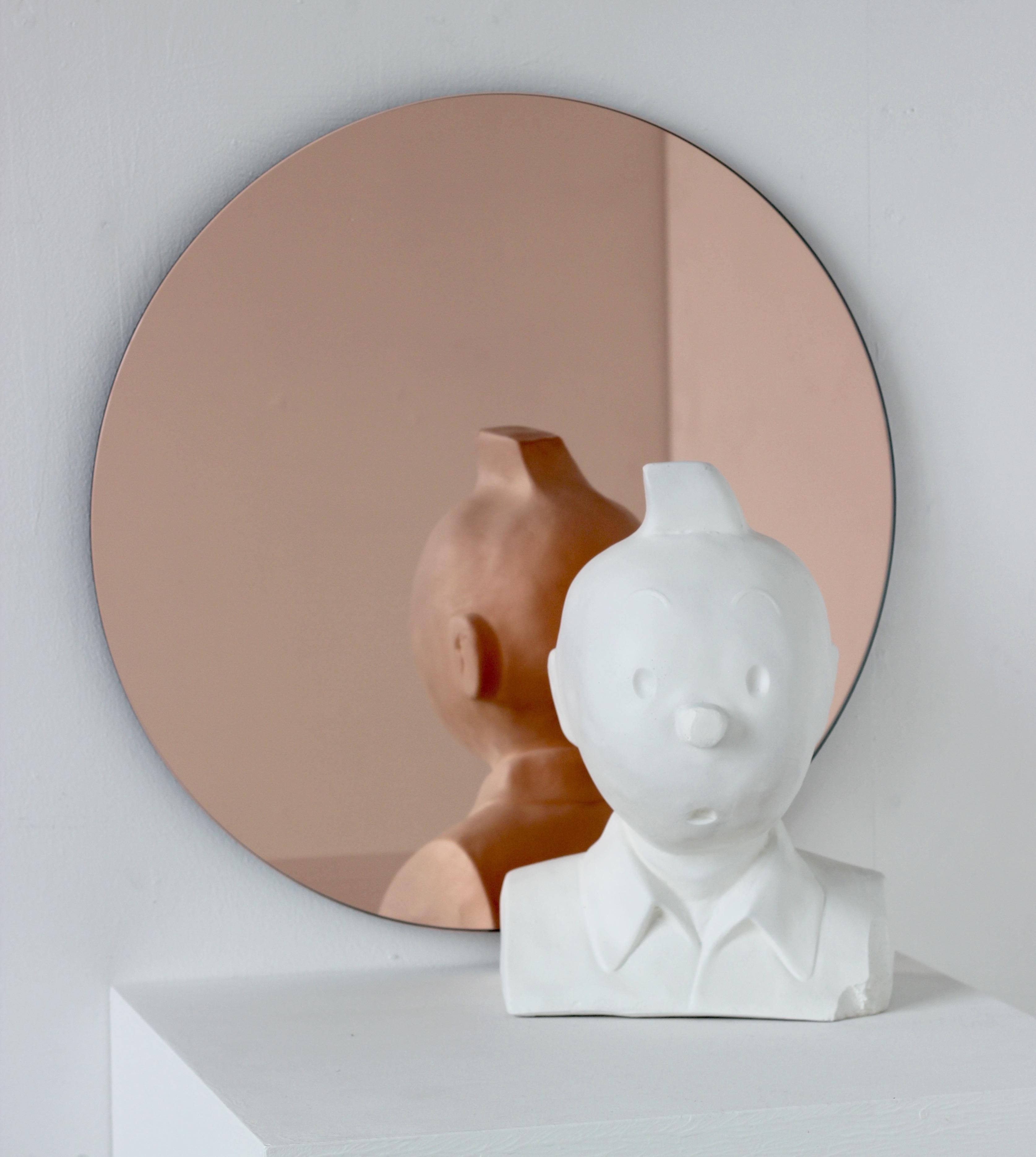 Charming and minimalist rose gold / peach tinted round frameless Orbis™ mirror with a floating effect. Quality design that ensures the mirror sits perfectly parallel to the wall. Designed and made in London, UK.

Fitted with professional plates not