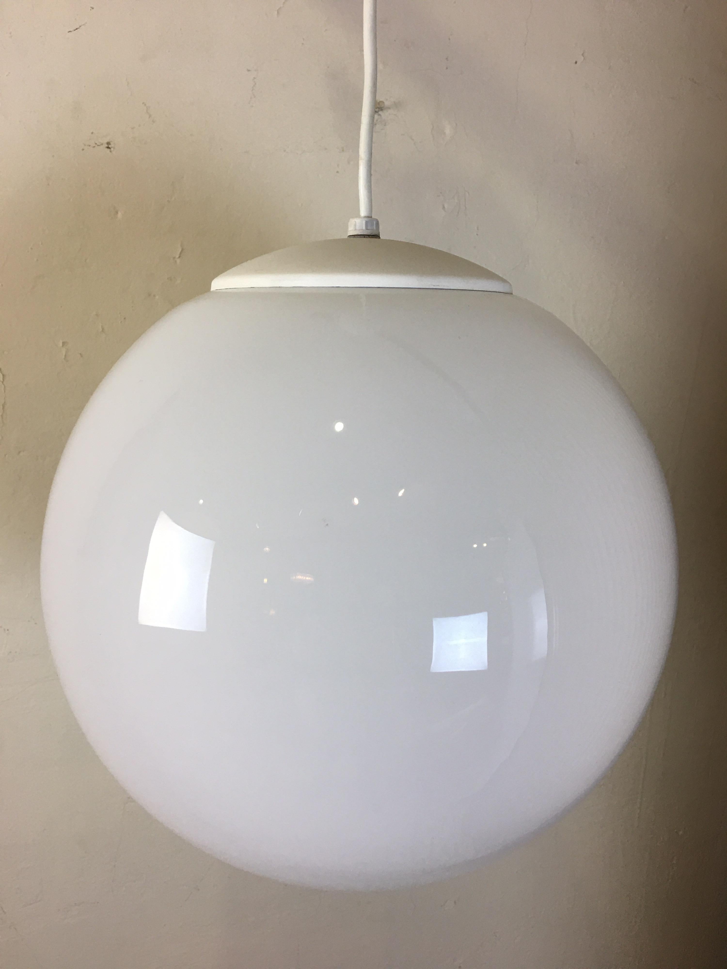Simple elegant milk glass ball ceiling fixture. Dates to the late 1950s or early 1960s. Produced in Cleveland Ohio. Globe is a little bigger than 13