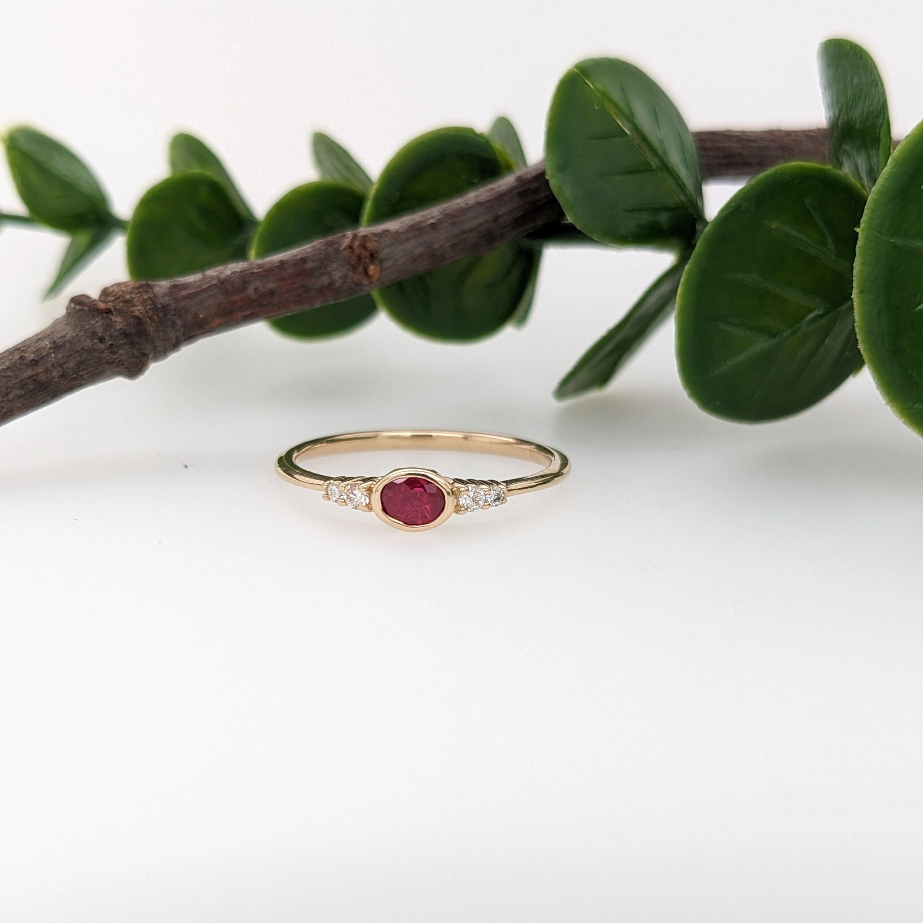 A  dainty east west ring is perfect for the minimalist in your life or for giving someone their first piece of jewelry :) This ruby presents a mixture of red hues which is perfectly accentuated by two diamonds on each side. The slim yellow gold
