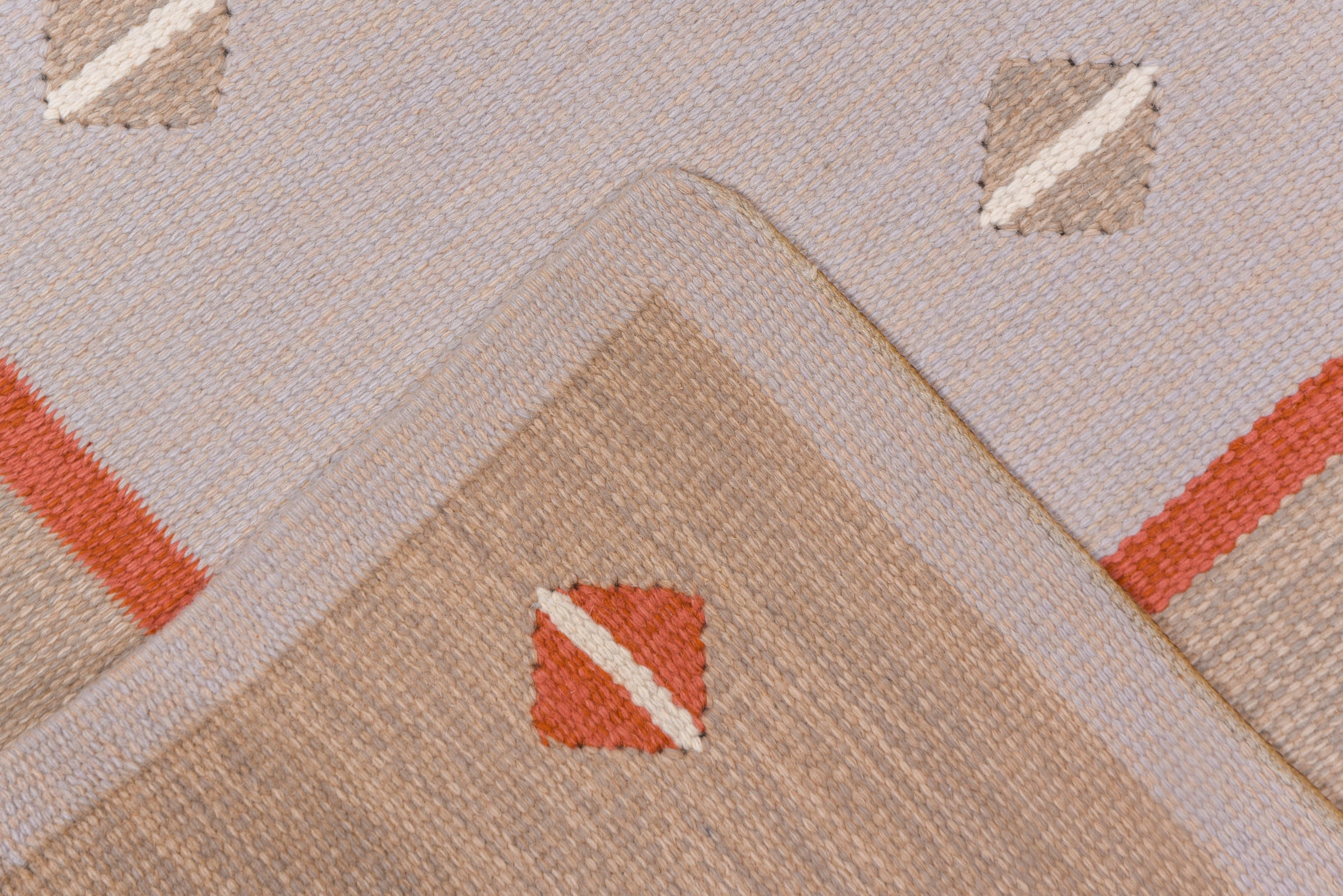 This Scandinavian flatweave shows a similar field and border pattern of small, paired, back-to-back triangles in light brown and rust respectively, on pink grounds. Shared warp tapestry weave, wool pattern wefts. As new condition. Minimalist design.