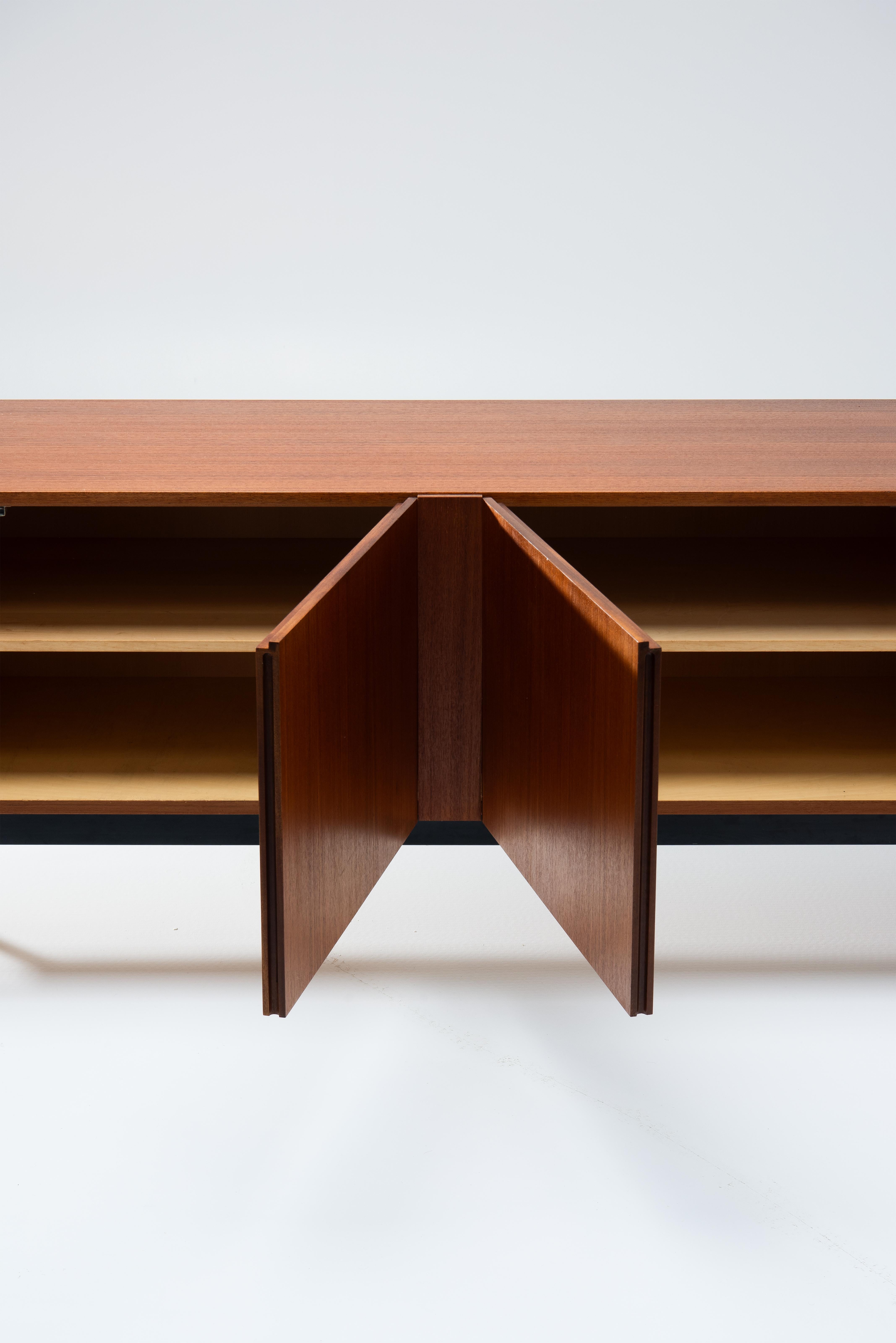 B-40 sideboard in veneered teak with a black lacquered steel frame, designed by the Swiss architect Dieter Waeckerlin in 1958. Produced by Behr, Germany. It contains 4 drawers and a mobile beverage cart in maple with light blue formica inlay. This