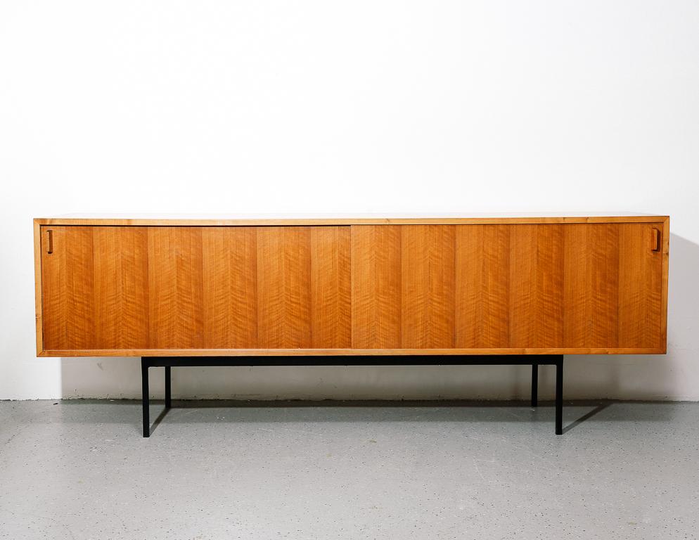 Sideboard designed by Minimalist pioneer Dieter Waeckerlin for Idealheim, Basel. On black painted steel base. Signed by the manufacturer.