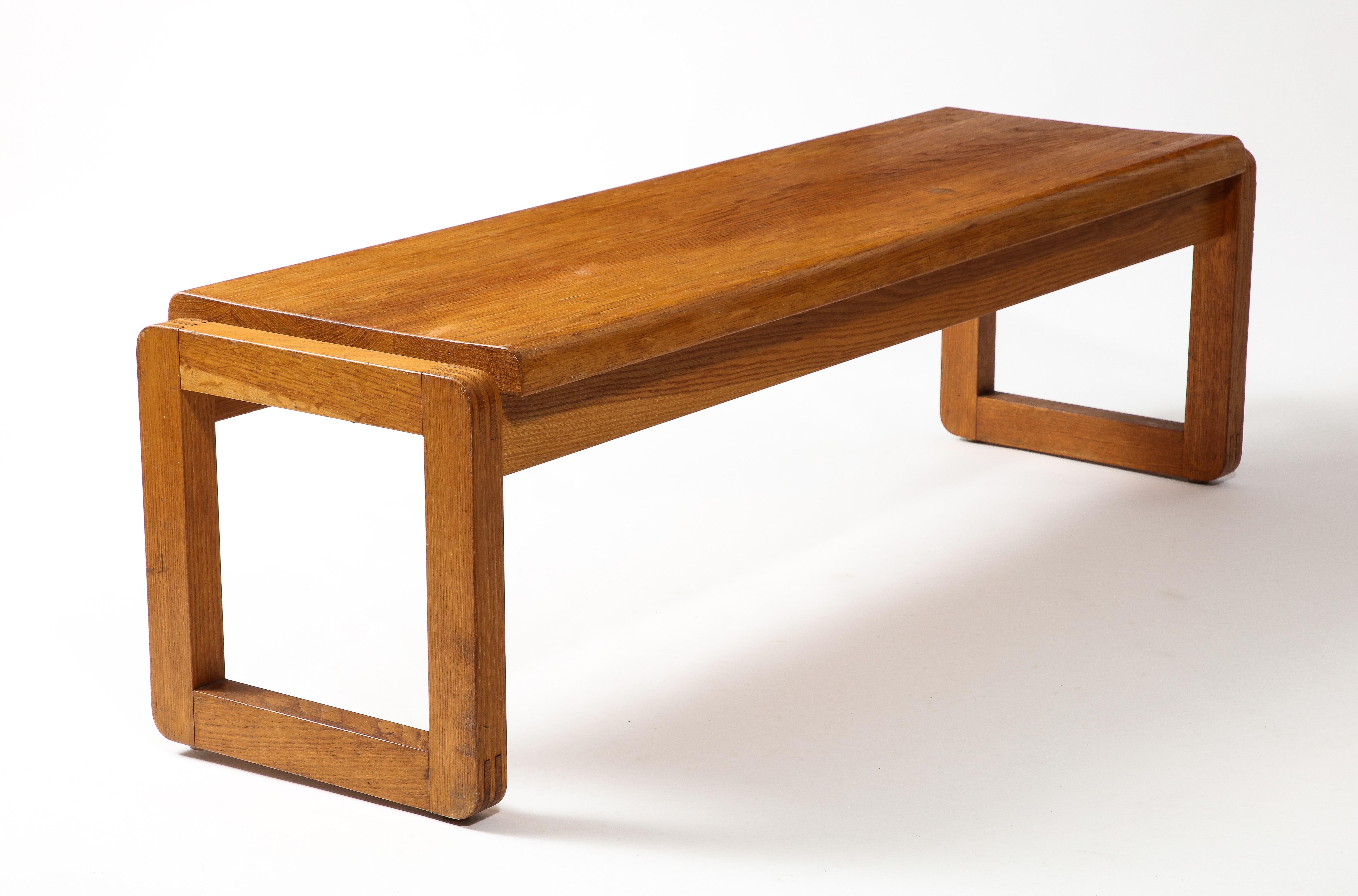 Beautifully crafted and assembled solid natural oak bench in the style of Guillerme and Chambron.  With visible nail, screw or tourillon this bench features a very sleek line. Its upper seating surface overflows from the square support
