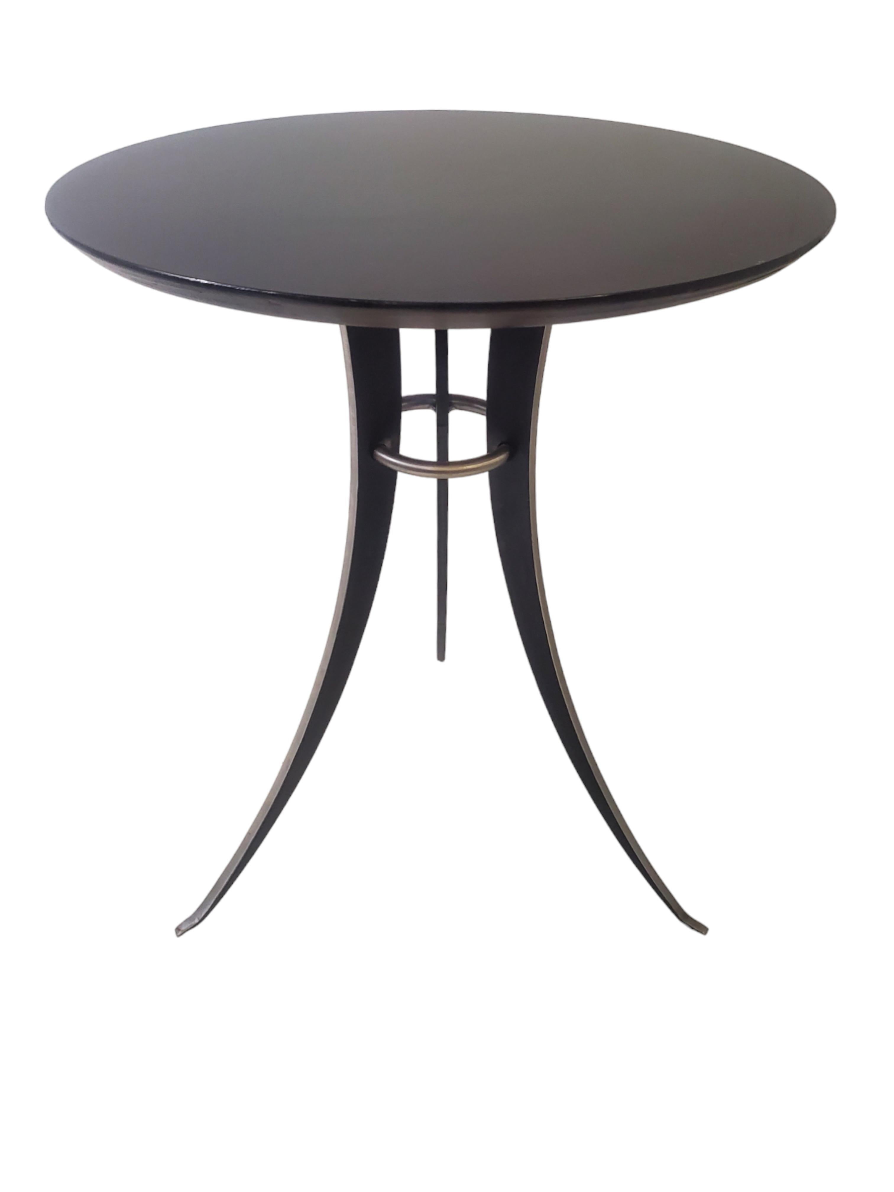 ( A pair is available ) 
A Minimalist  Mid Century Modern tulip design, splay leg end table in steel and lacquered wood in the style of Osvaldo Borsani.
The austere and streamline design make this table appealing in any decor. 
The delicate tapering