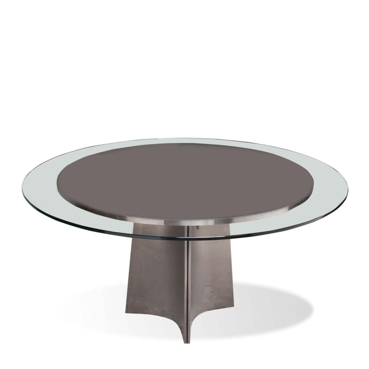 A Minimalist dining table with round glass top and brushed steel base for Arrmet. Reminiscent of designs by Maison Jansen. Italy, circa 1970. 

Dimensions: 52 inches W x 29 inches H.