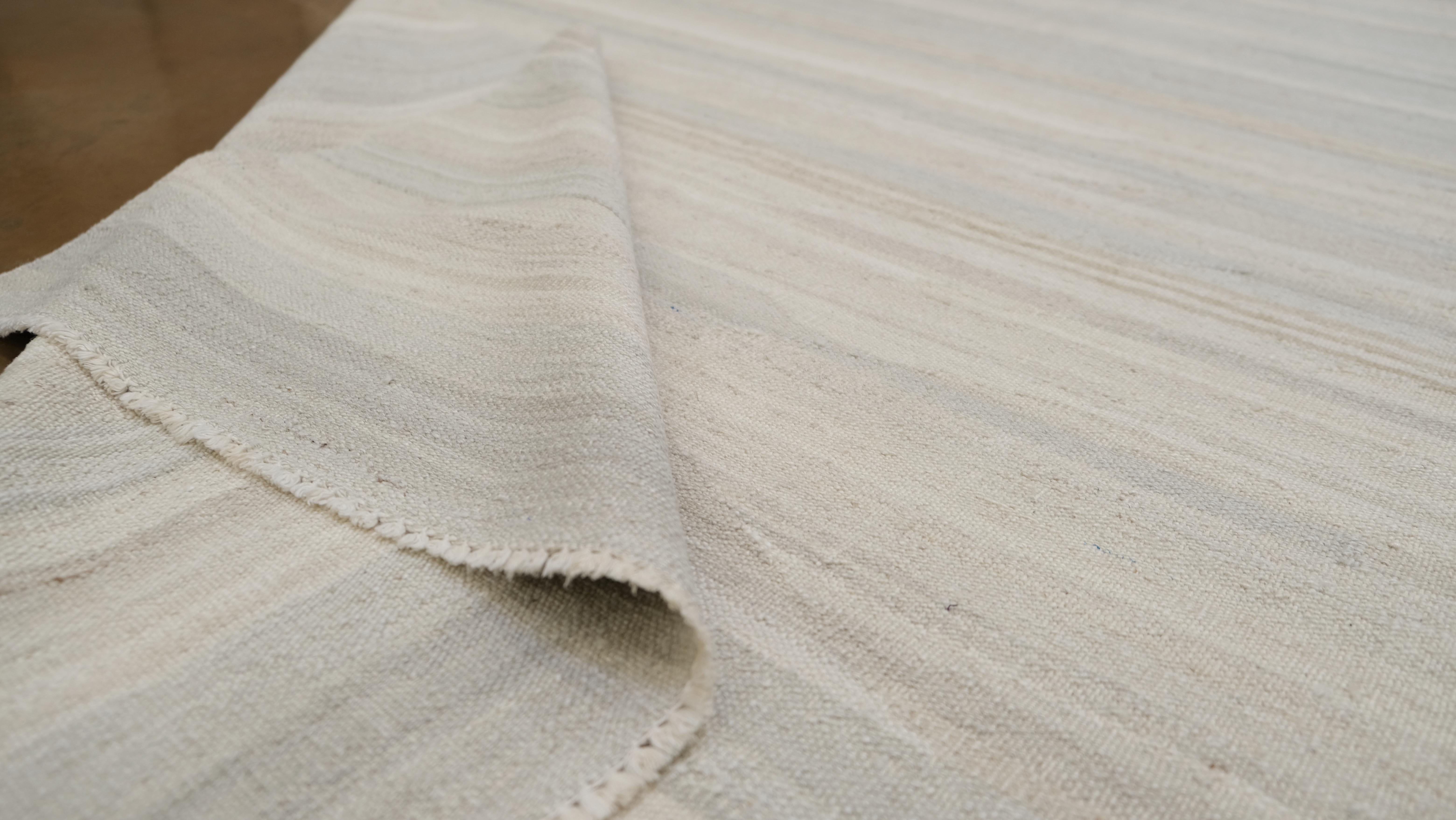 Featuring a serene neutral palette with soft, horizontal striped patterns, this rug offers a contemporary minimalist design that effortlessly blends with various interior styles, including modern, Scandinavian, and transitional aesthetics.

Crafted