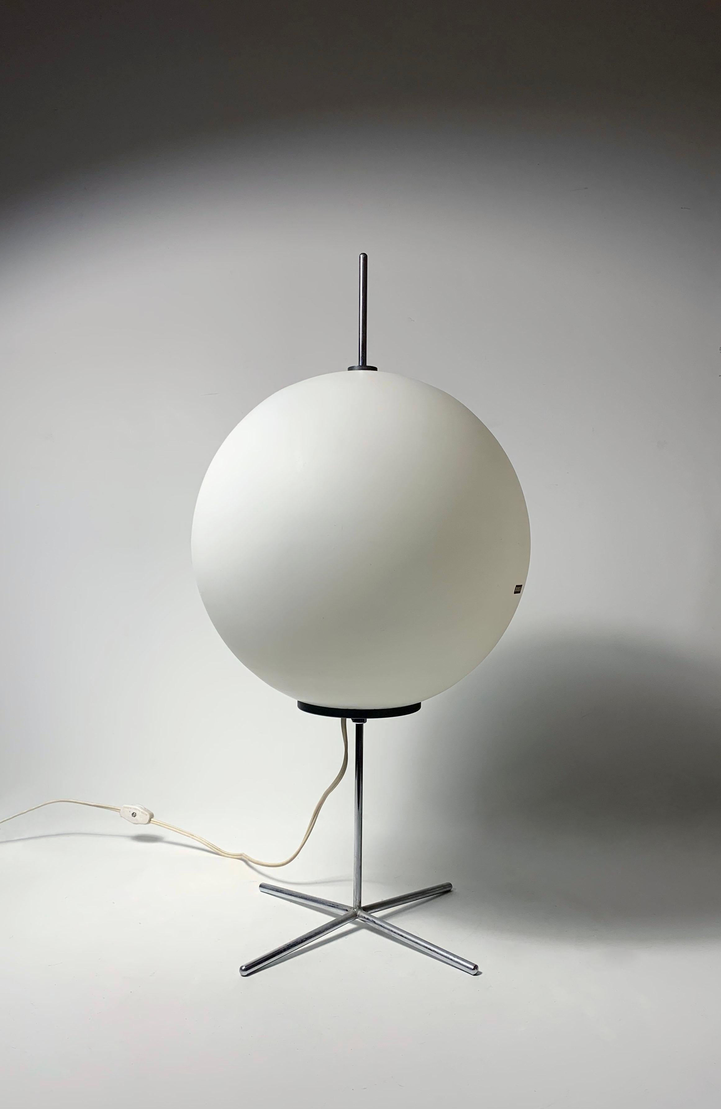 Minimalist table lamp by Wilhelm Braun Feldweg for Doria Leuchten . A translucent glass globe floating on a chromed cruciform base. 

Sticker remains on the globe and the underside. 

Some light ware as shown.