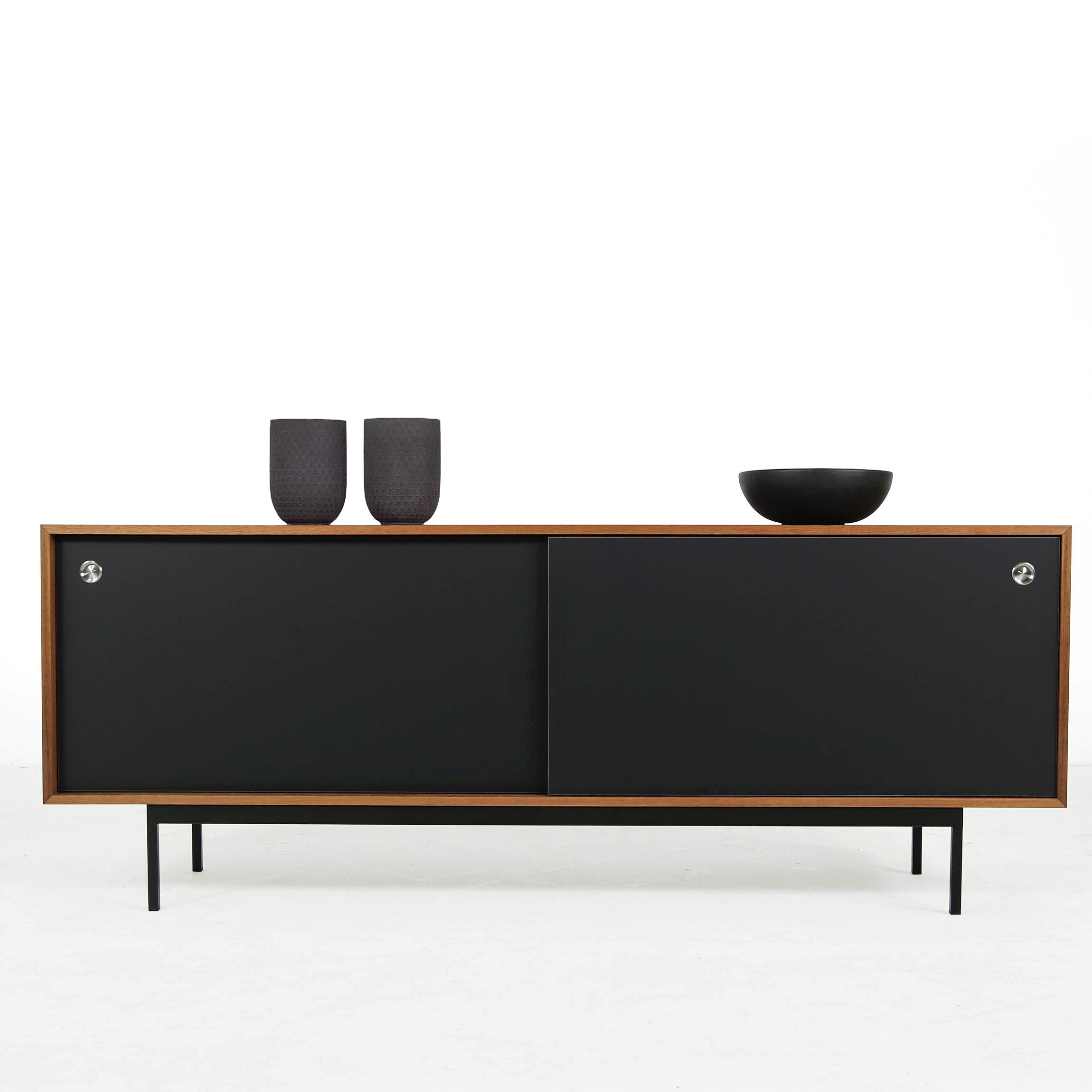 Beautiful teak sideboard, freestanding, made in Germany, design by Nathan Lindberg (Nathan Lindberg Design)
Black HPL (Formica) sliding doors with stainless steel door handles, iron base powder coated in black.
Best condition, the sideboard was