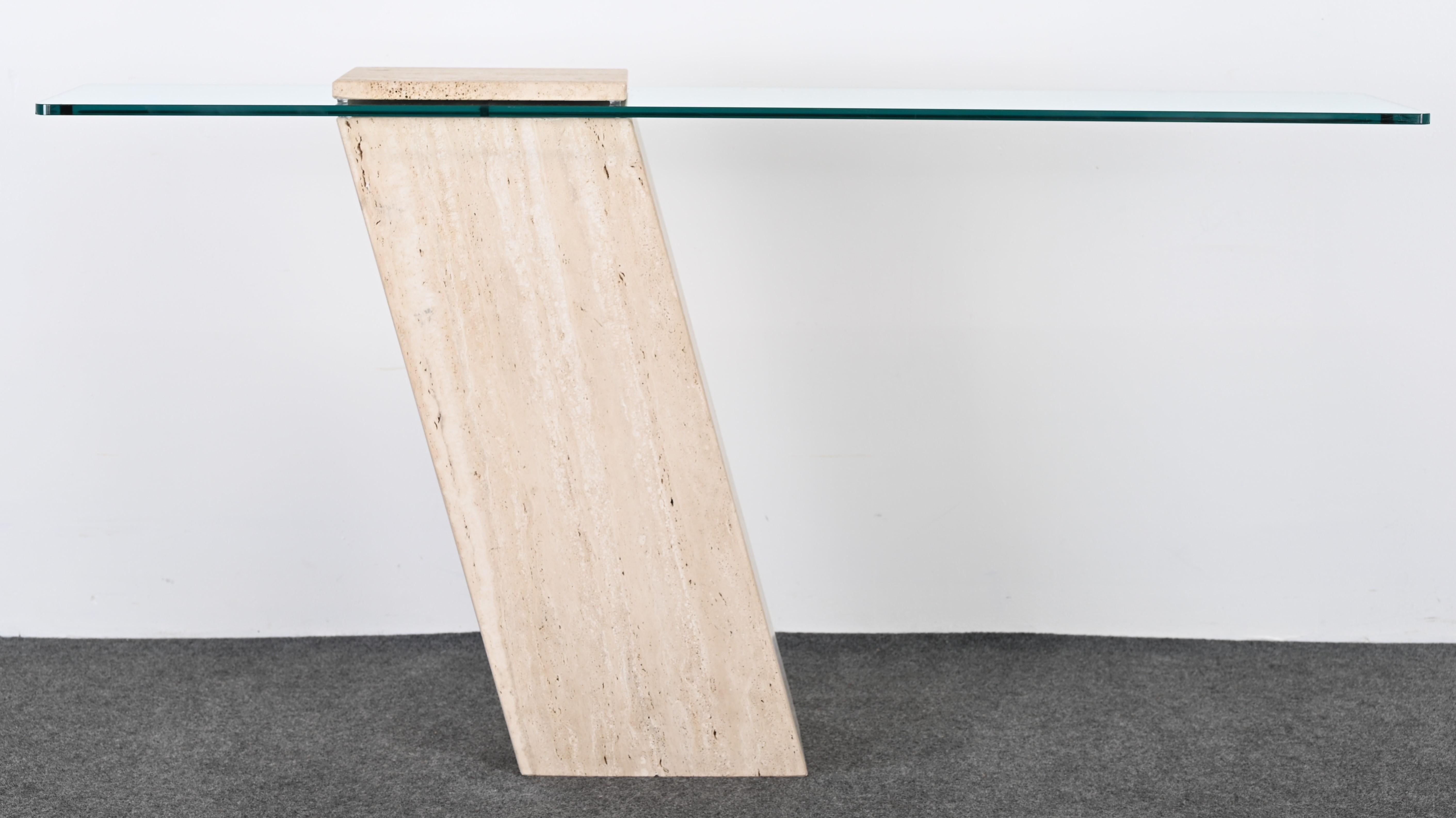 A beautiful minimalist travertine marble and glass console table. This cantilever console table would look great in any Mid-Century Modern, Contemporary or Traditional interior. The marble table is in overall very good condition. There is a slightly