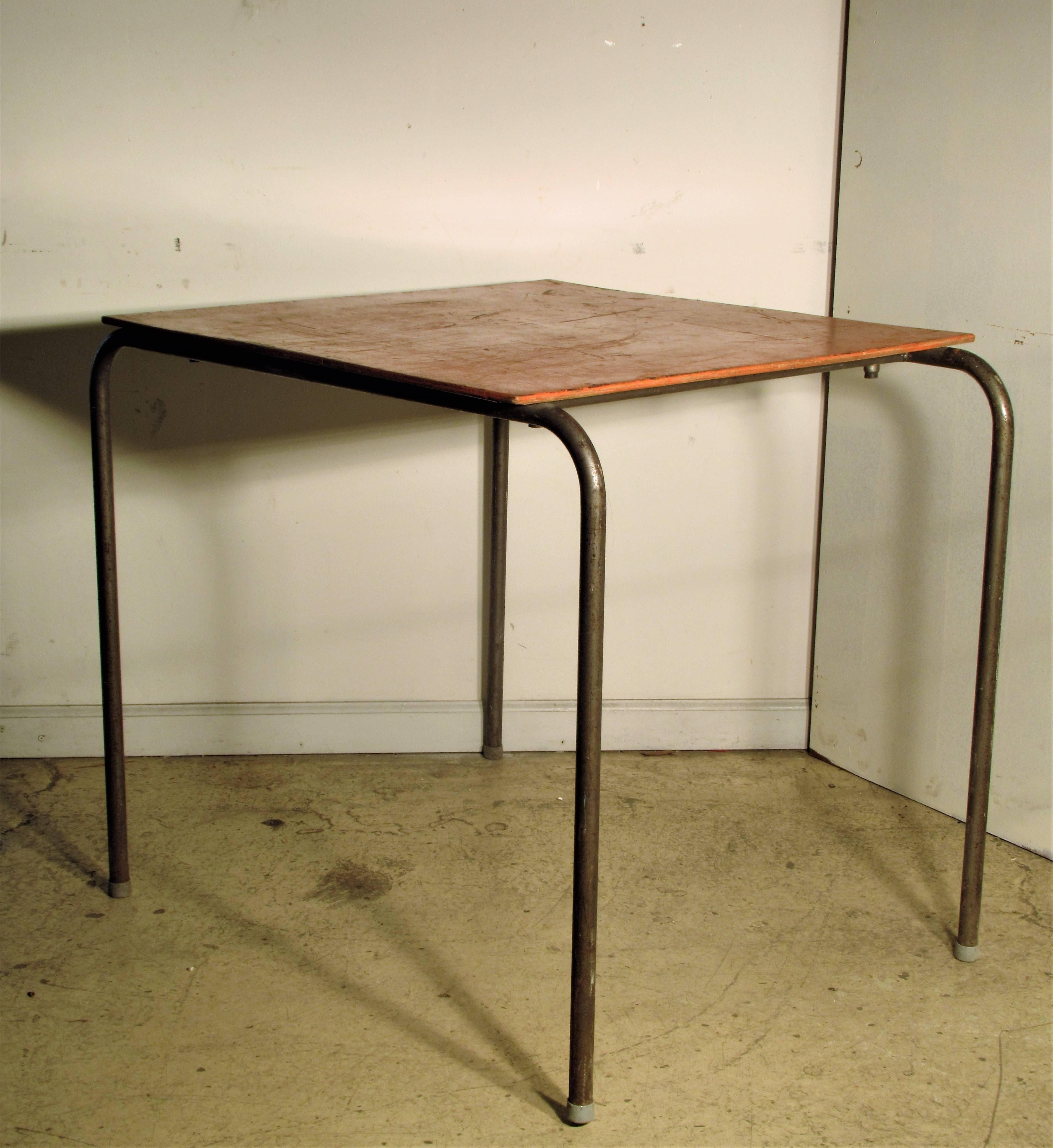 Silver gray finish tubular steel table with original orange painted wood top. Beautiful minimalist asymmetrical sculptural form in the Dutch Modernist or Bauhaus style of Marcel Breuer/circa 1930-1950.