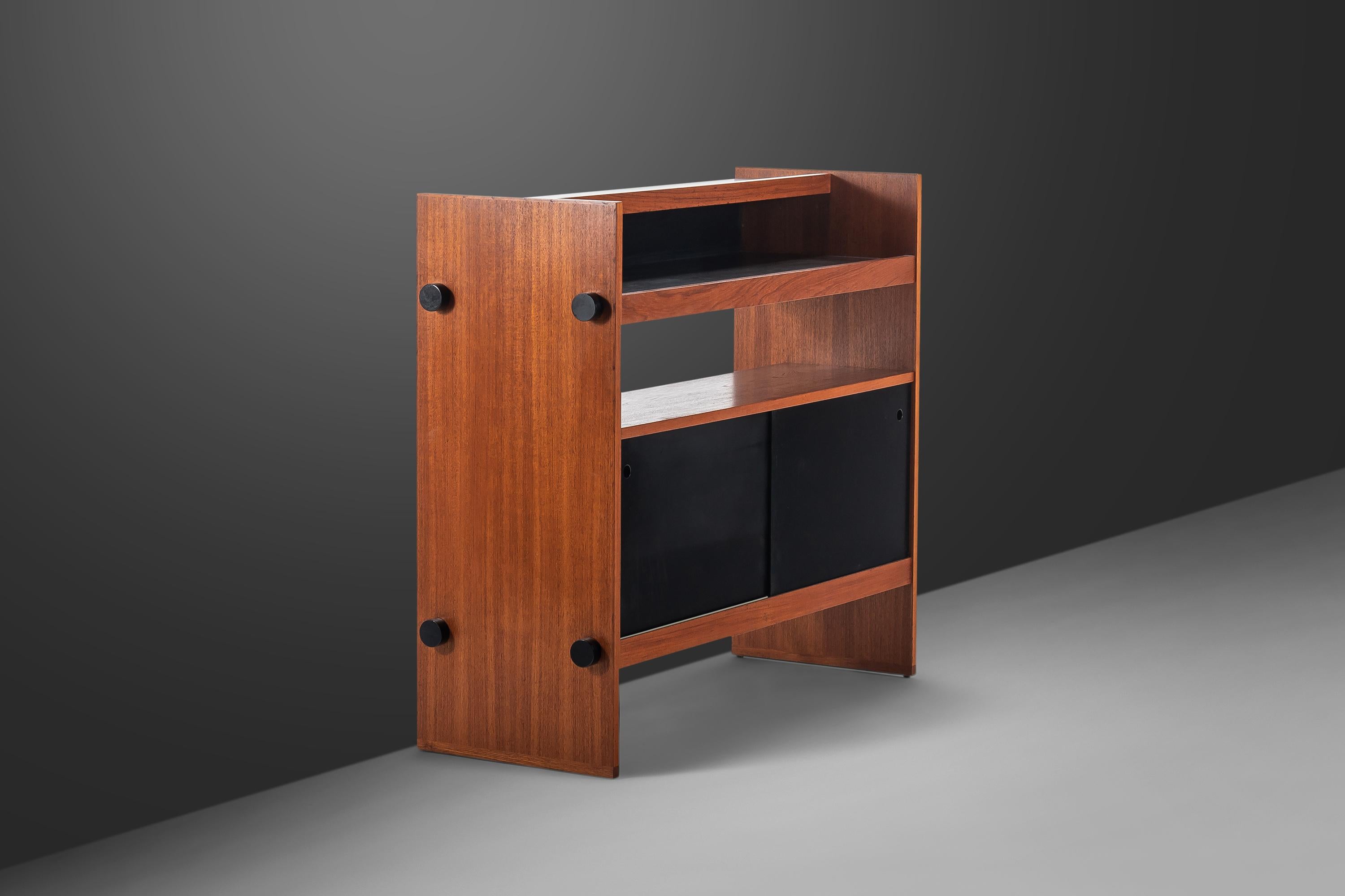 Introducing an exceptional Danish-made dry-bar with ultra-minimalist lines and stance. This petite bar is the epitome of functional art and the perfect example of what two contrasting tones can do in a single piece of furniture with flat black