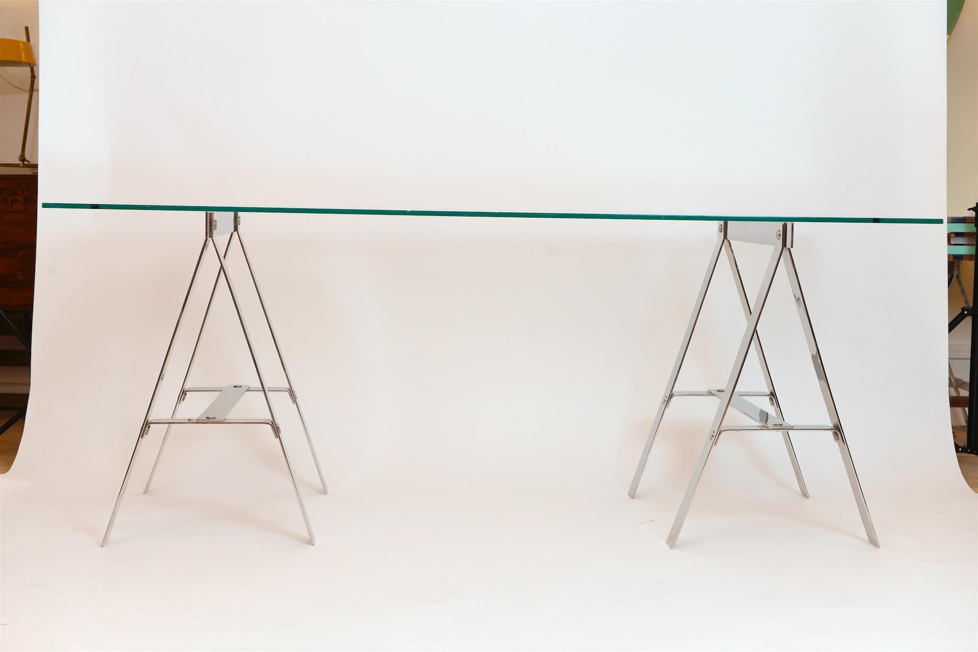 Minimalist midcentury chrome and glass trestle table, Italy, circa 1960

Can be shipped without glass

Glass has small chip to one side.