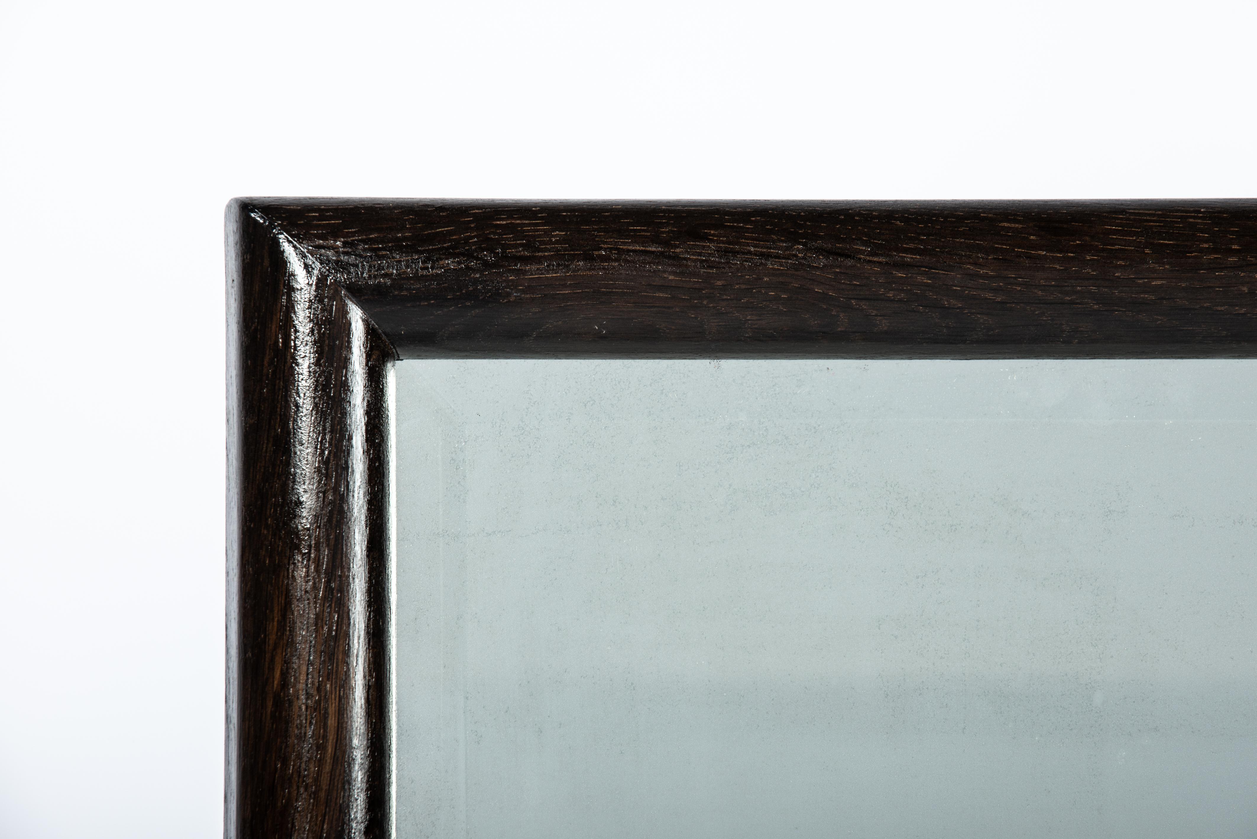 Dutch Minimalistic Dark brown/black solid oak mirror frame with antique facetted mirro For Sale