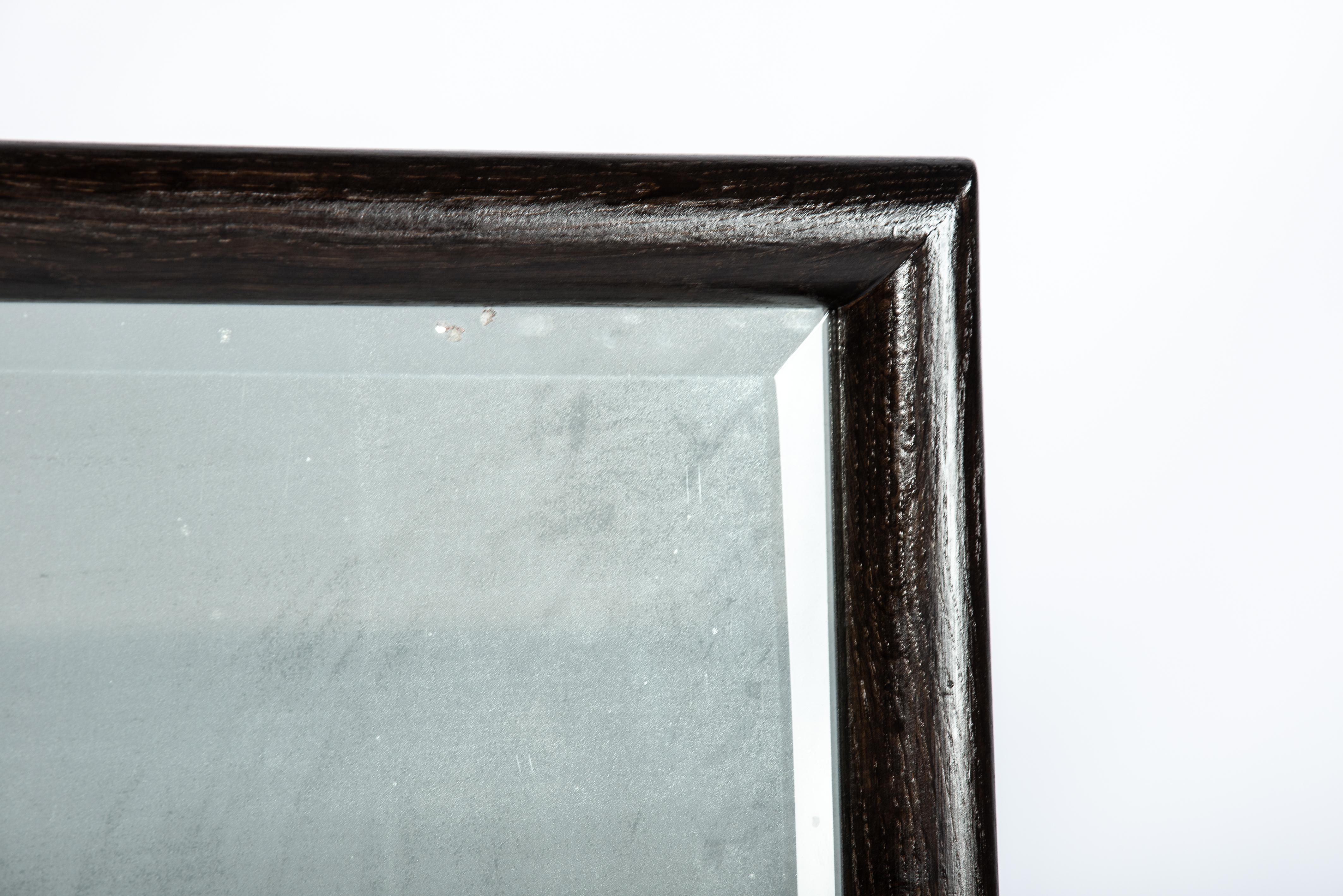 Faceted Minimalistic Dark brown/black solid oak mirror frame with antique facetted mirro For Sale
