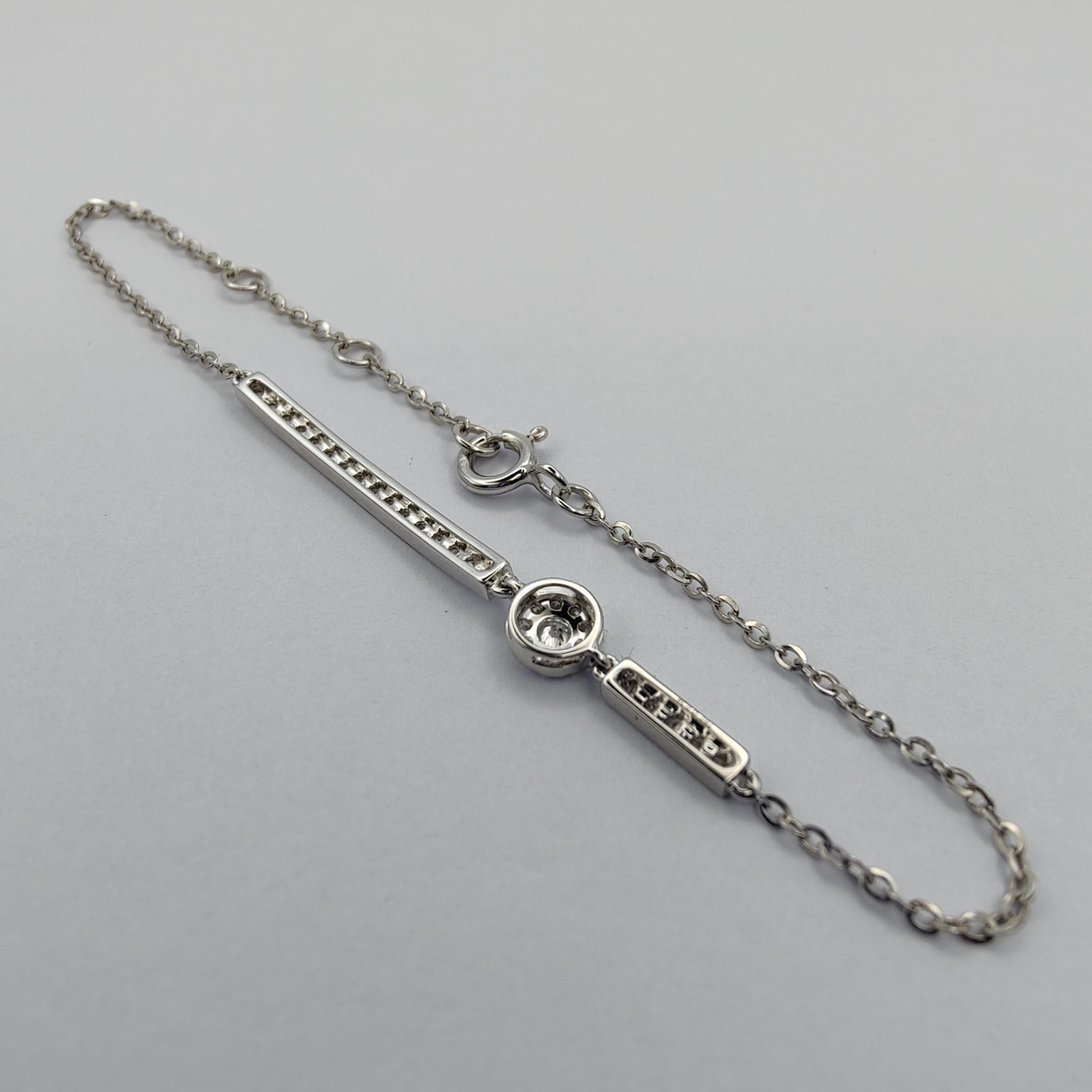 This elegant diamond bracelet is the perfect accessory for anybody looking to add a touch of sparkle to her everyday look. The bracelet is made of 18k white gold and features a delicate chain adorned with 31 sparkling diamonds, including a single