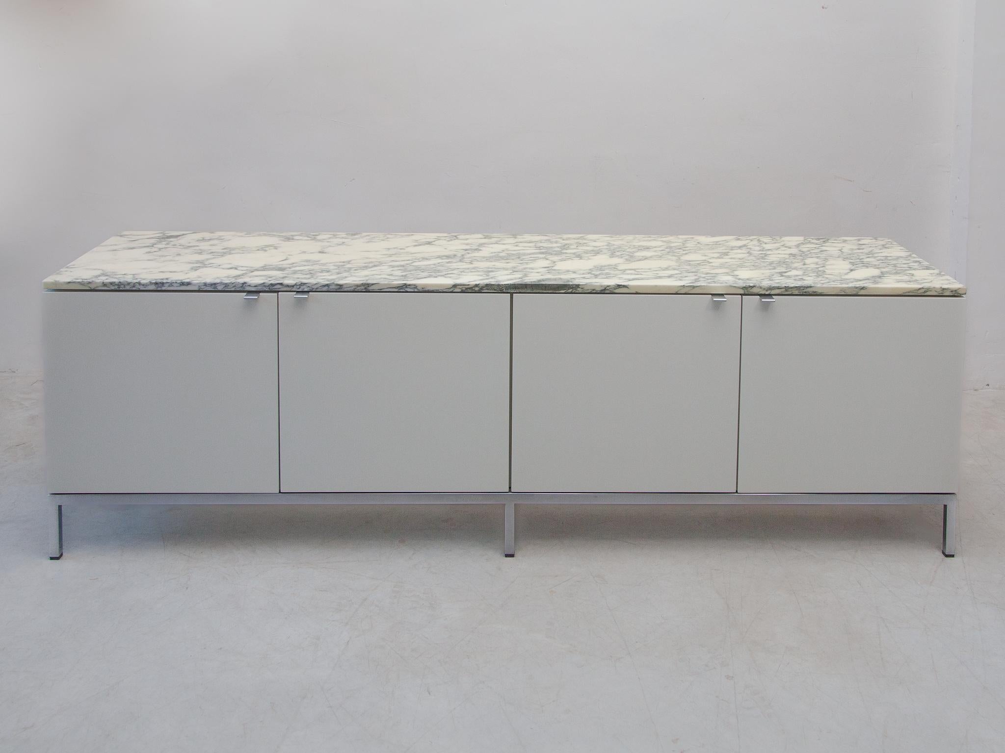 Marble top, four doors, luxurious sideboard designed by Florence Knoll for Knoll International, 1960s. Freestanding minimalistic sideboard with elegant details equipped and smart storage facilities. This piece gets an special quality appearance due