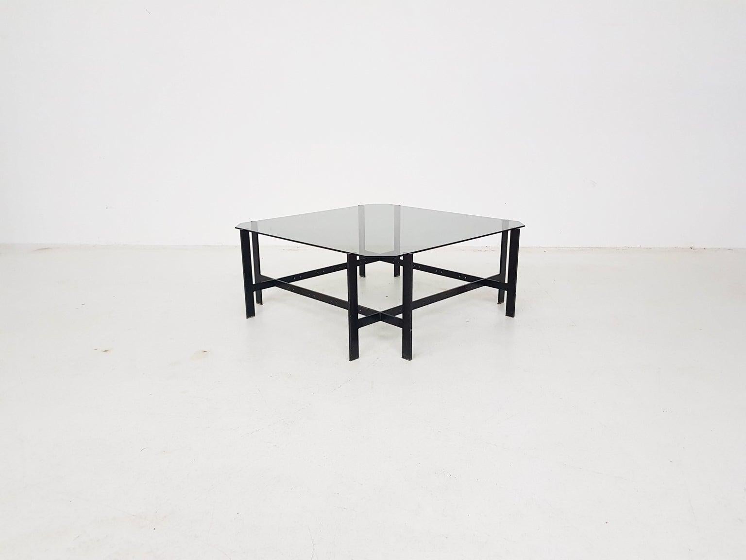 Minimalistic and geometric shaped Mid-Century Modern black metal coffee table with a glass top from circa 1960s.

This table is perfect example of minimalistic midcentury design. A spatially designed coffee table with beautiful geometric