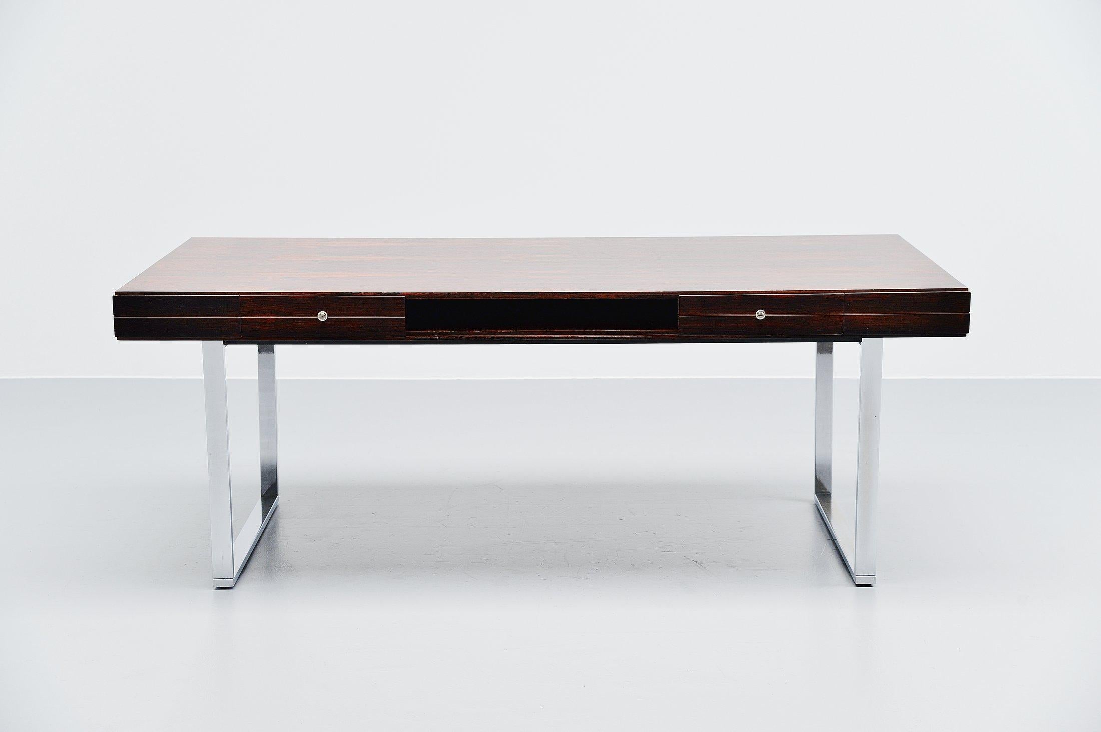 Fantastic Minimalist rosewood desk made by unknown manucaturerer, Denmark 1960. The desk is very well crafted, a floating rosewood casing supported by chrome-plated legs. Very nicely dynamic shaped desk which has been fully refinished. The desk has