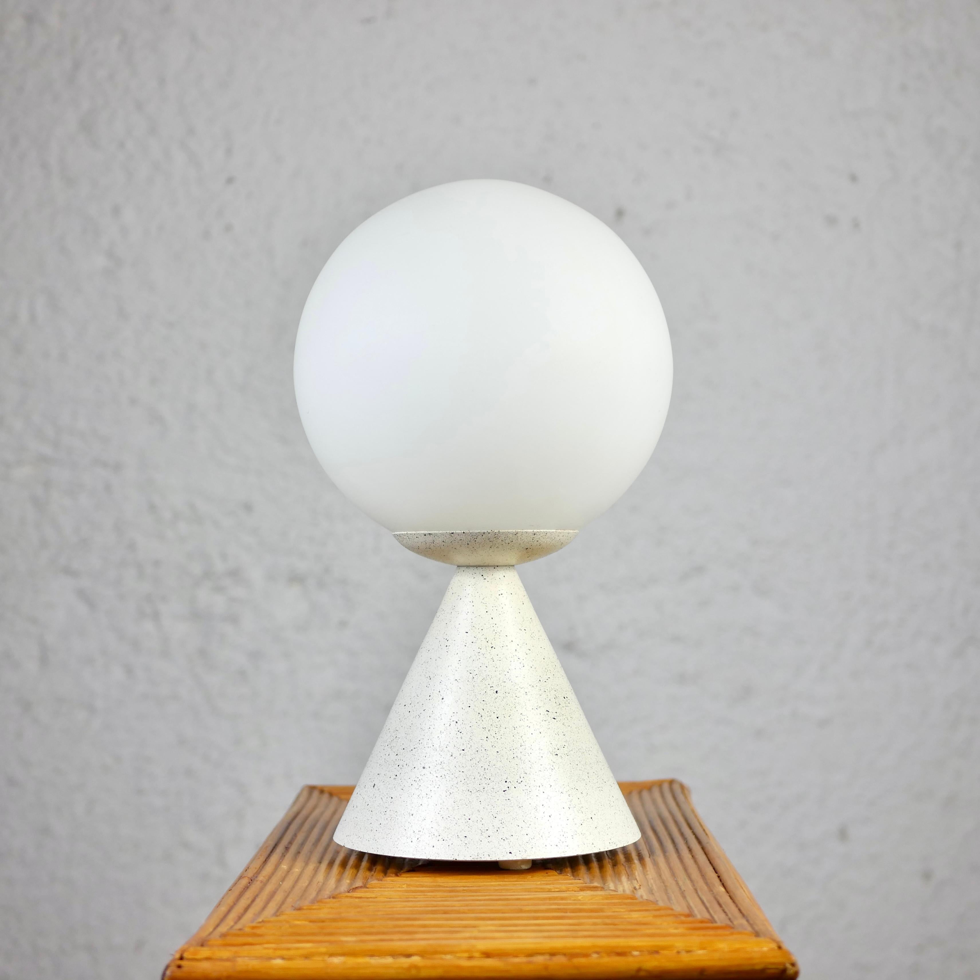 Beautiful and minimalistic table lamp made in France by SCE, in the 1980s.
In the style of the Bilia lamp of Gio Ponti, it has a cream white and black spotted lacquered metal base, and a satin-finished glass sphere. 
Very good condition.
Dimensions