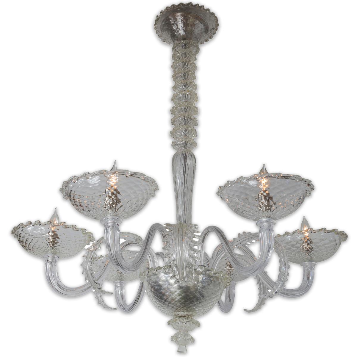  A stunning sleek crystal clear and iridescent blown chandelier with an exquisite center shaft composed of ten spherical mouth blown balls above a tapered stem upholding  six outreaching reeded blown arms above six deep bobeches adorned with frilly