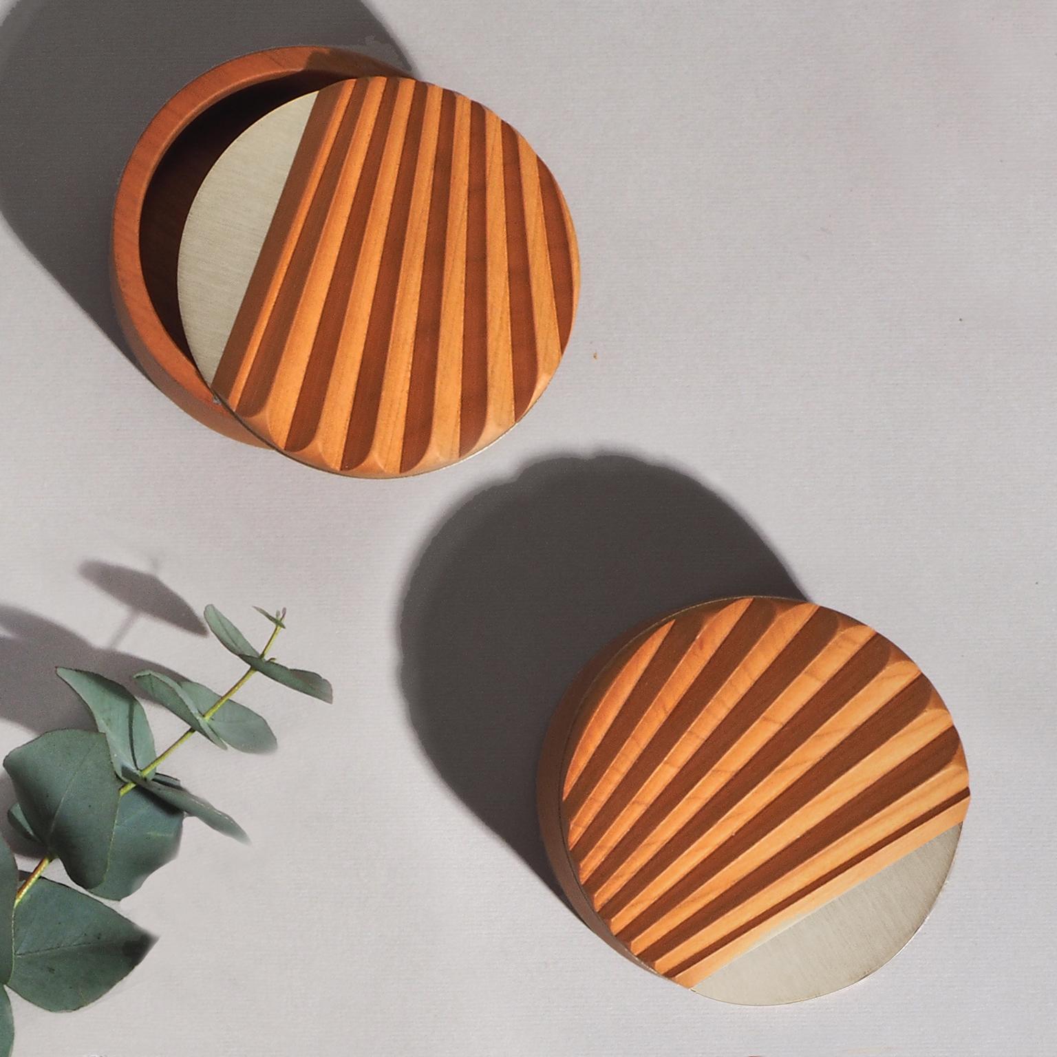 Designed by Studio Lido for Portego.
Made in Italy

The dot Miniportrait is part of the boxes line that reproduces the plissé of oriental fans.
It's expertisely manufactured carving a solid cherry wood making the surfaces smooth and