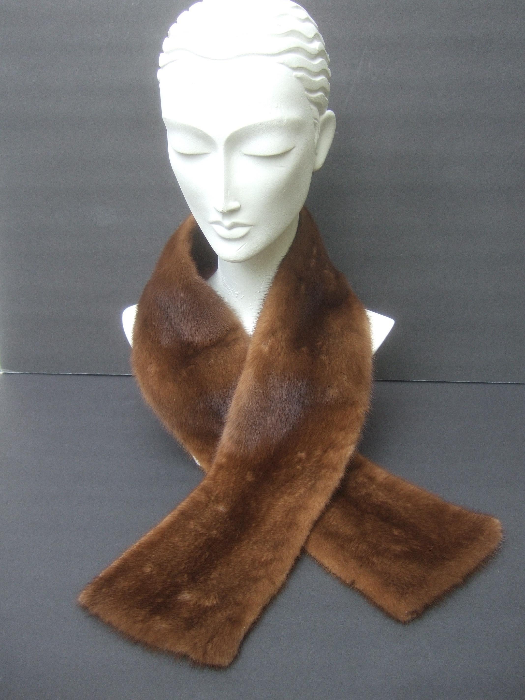 Plush mink fur collar designed by Pologeorgis for Neiman Marcus c 1990s
The luxurious brown mink fur collar is backed with brown satin acetate 
Makes a very chic accessory wrapped around the neck 

Designed without hooks or closures; rather wraps