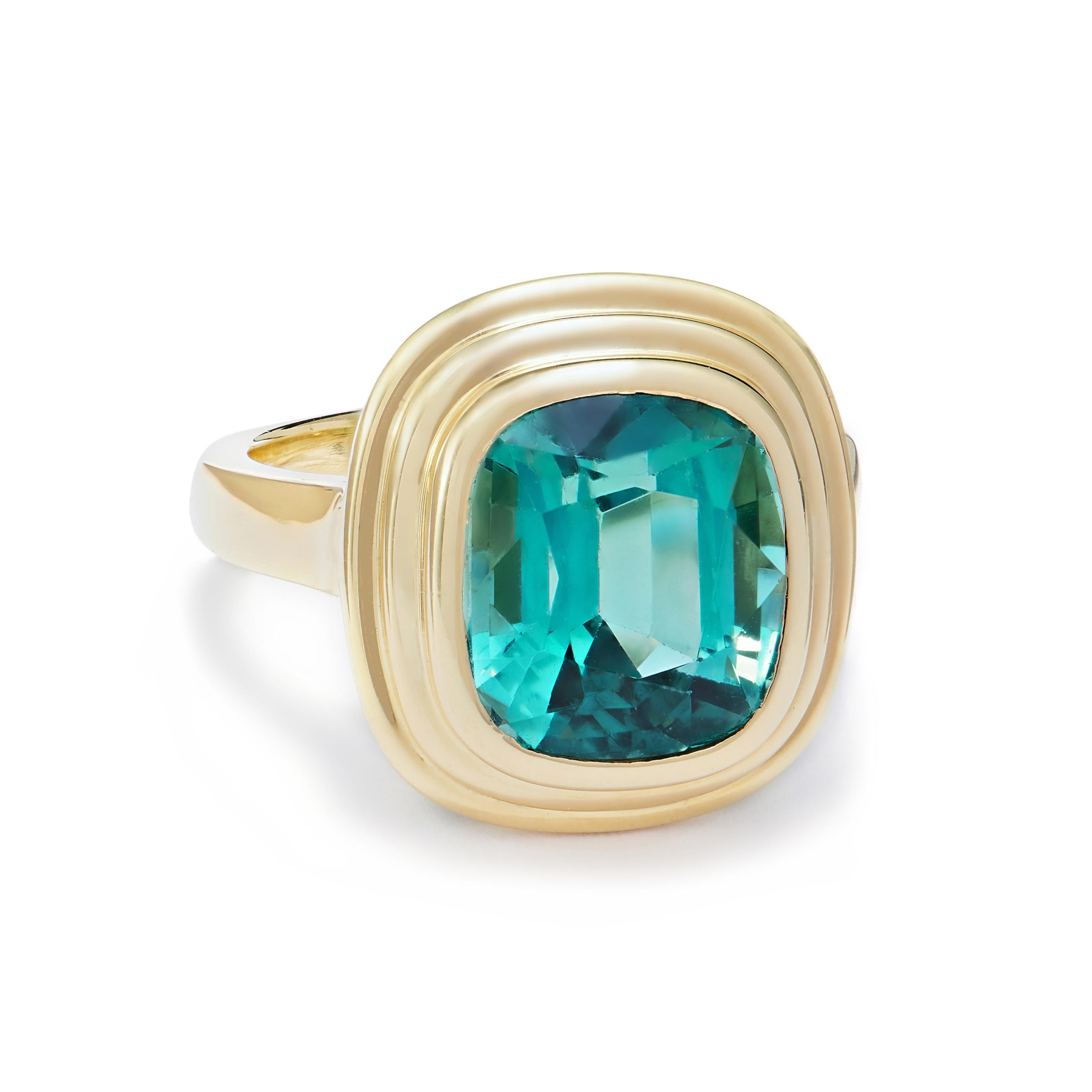 6.34 carat Blue Tourmaline ring set in 18 karat yellow gold. This beautiful blue Tourmaline is a one-of-a-kind Teal colour in a wonderful statement size, forever changing in different lights. The gemstone has a few minor natural inclusions (typical